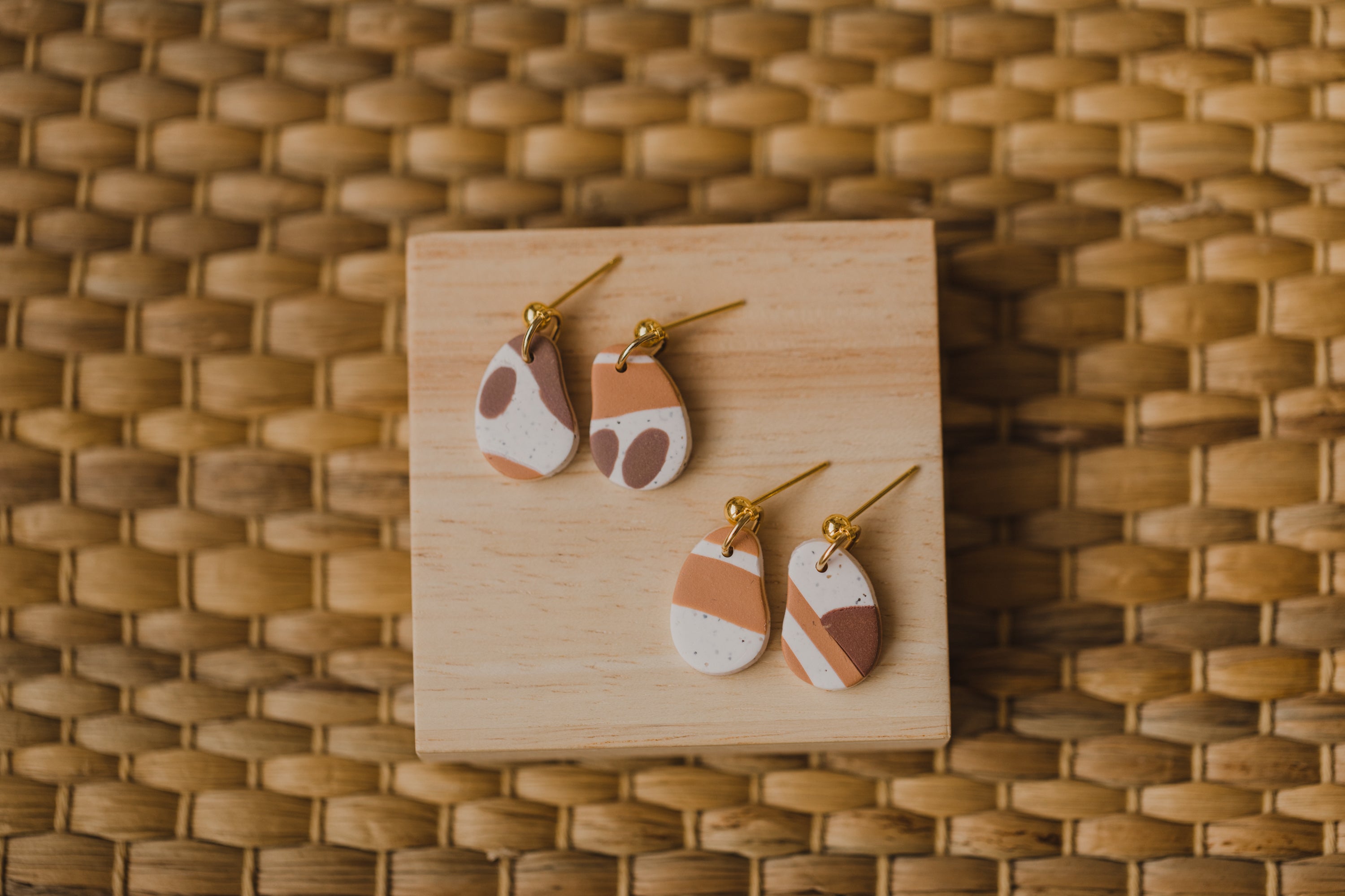 golden earrings with acrylic in white, petrol and brown
