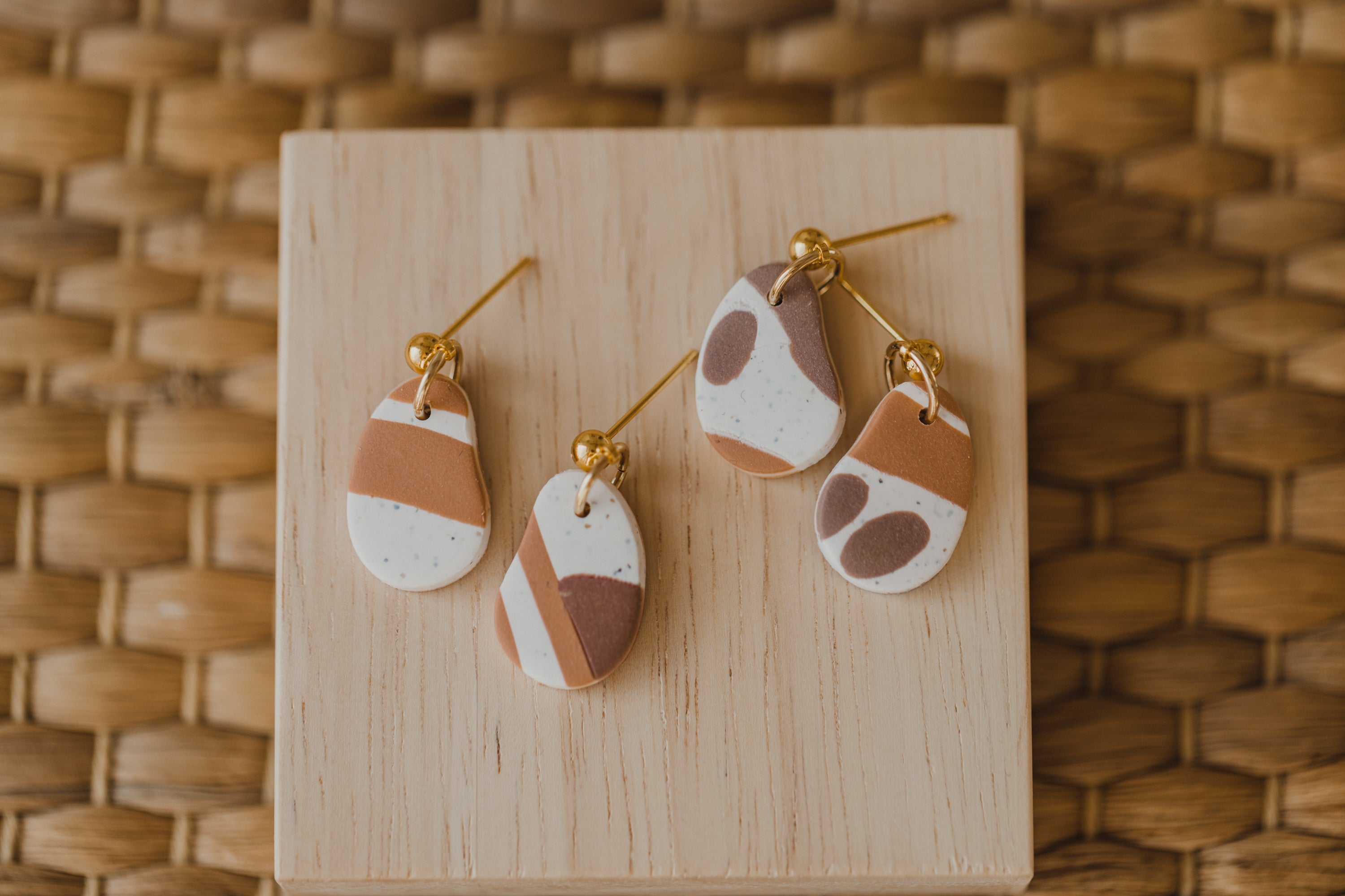 golden earrings with acrylic in white, petrol and brown