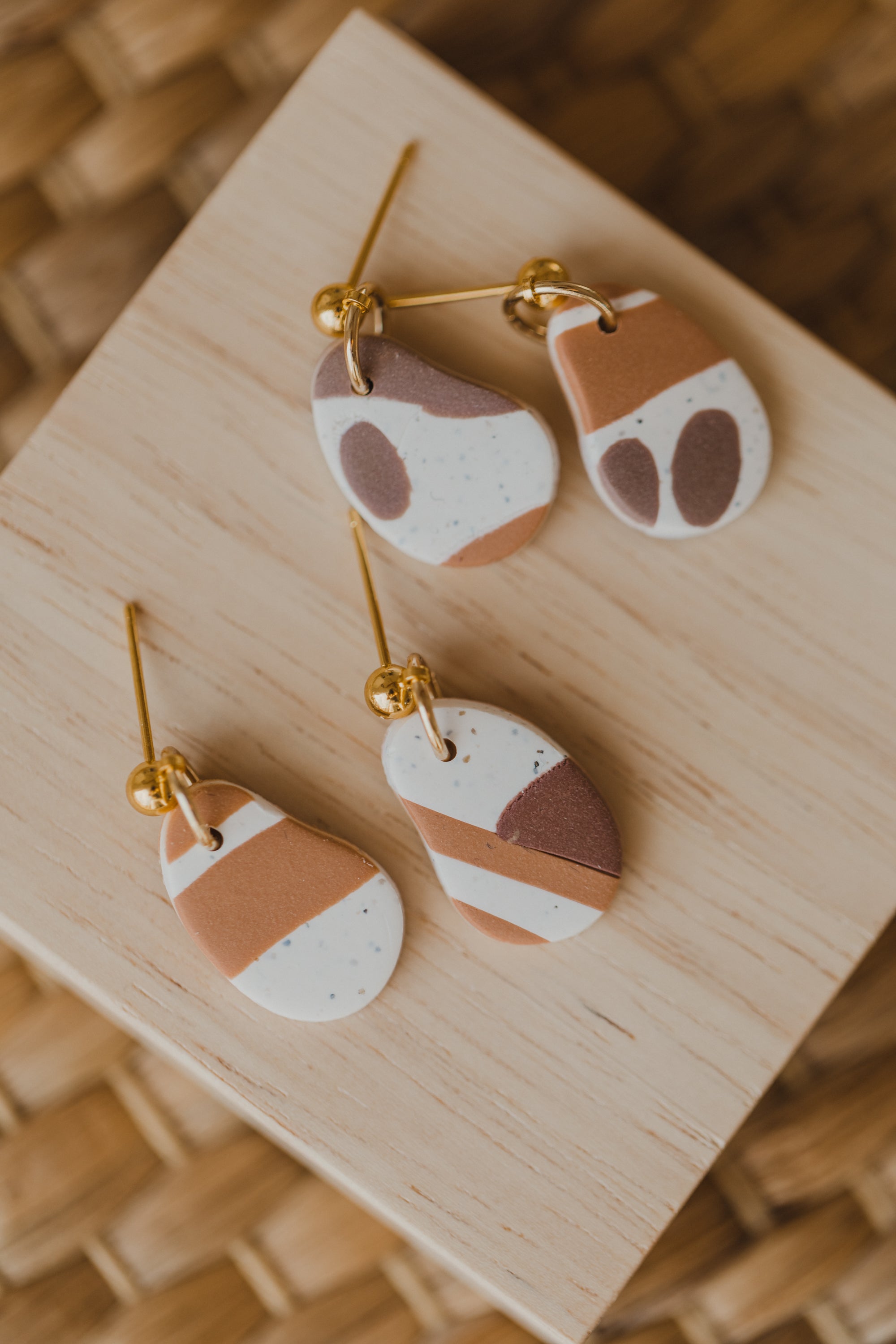 golden earrings with acrylic in white, petrol and brown
