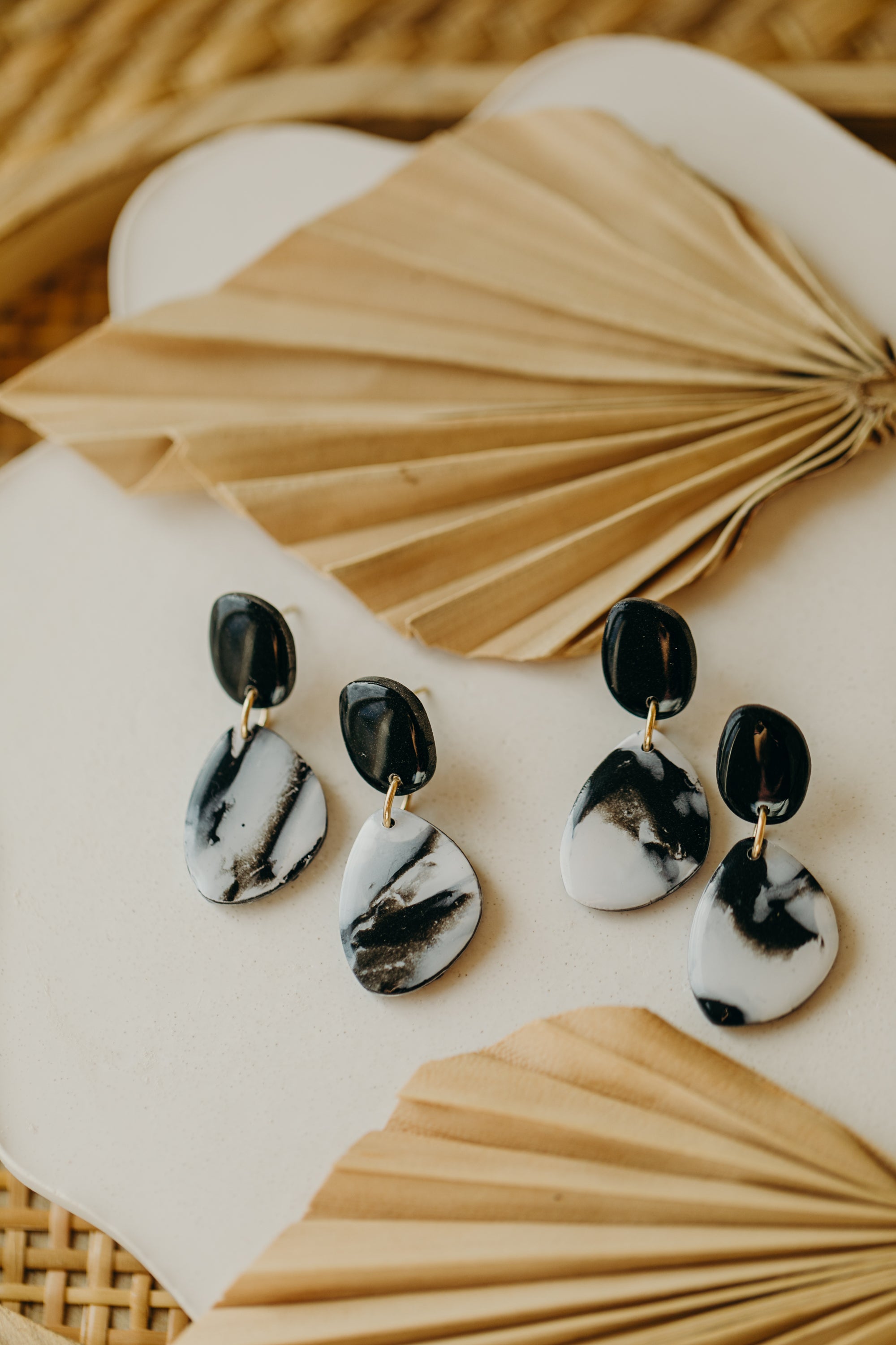 black polymer clay earrings with white pattern