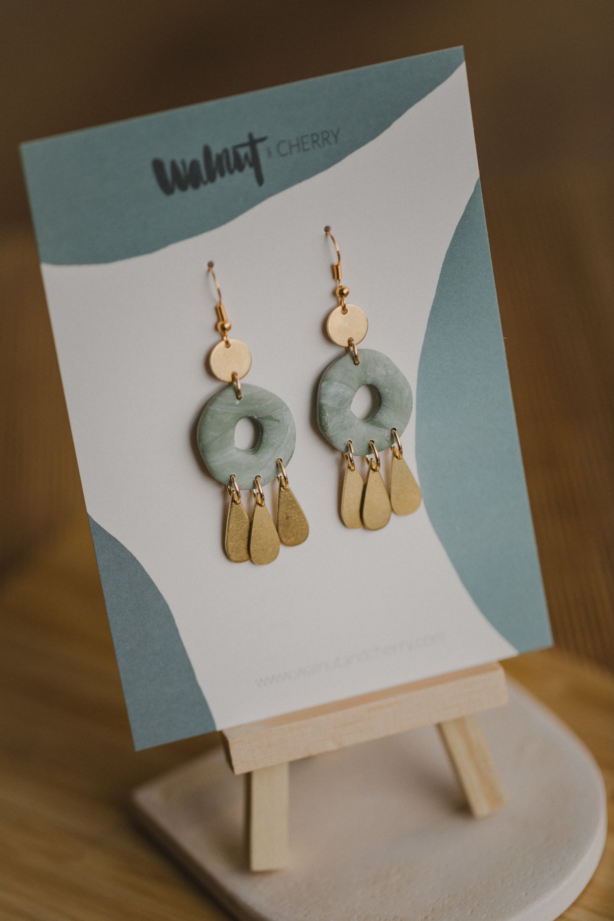 Hoop earrings with round polymer clay pendant and leaf