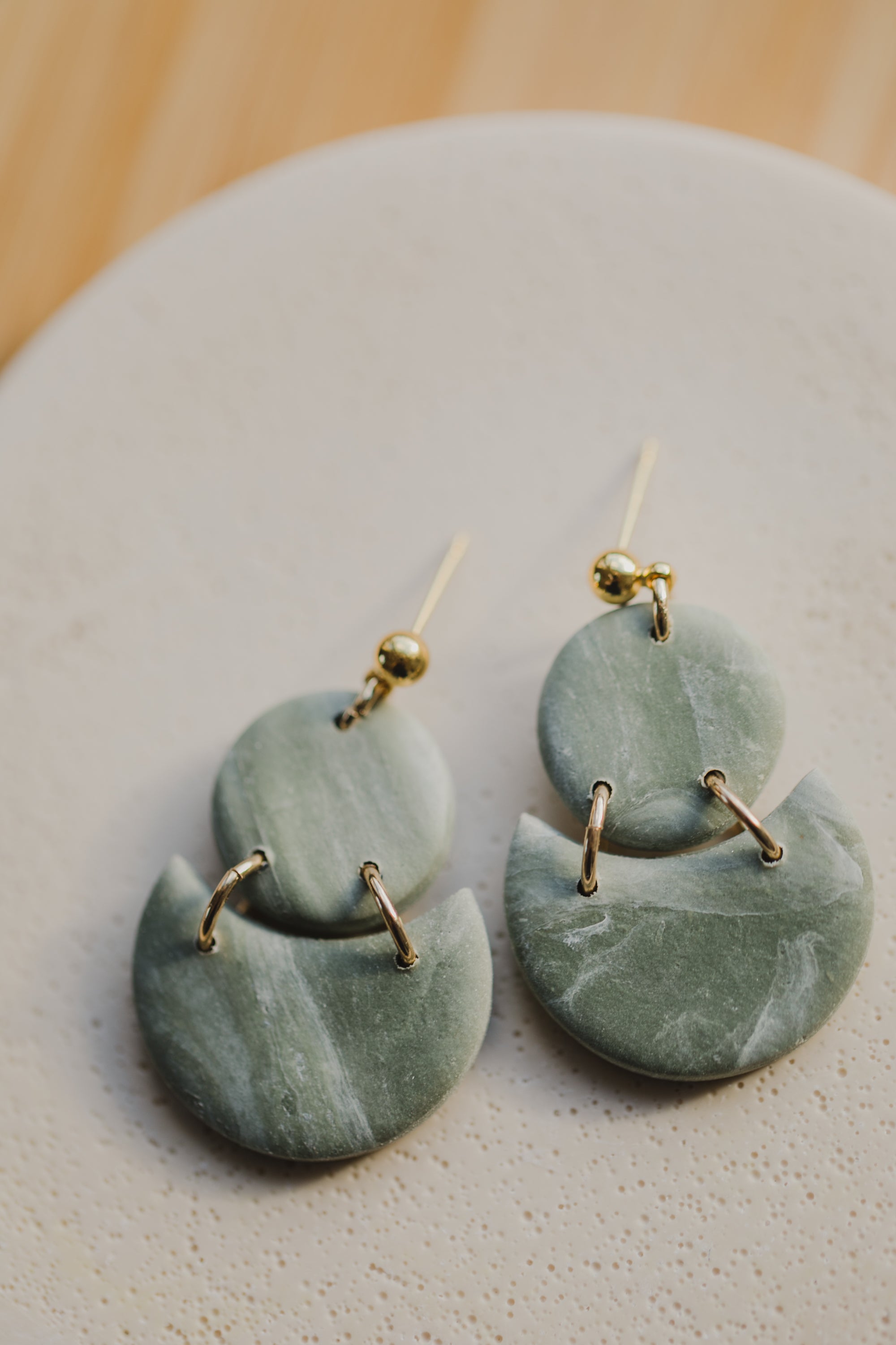 Hoop earrings with round polymer clay pendant and leaf