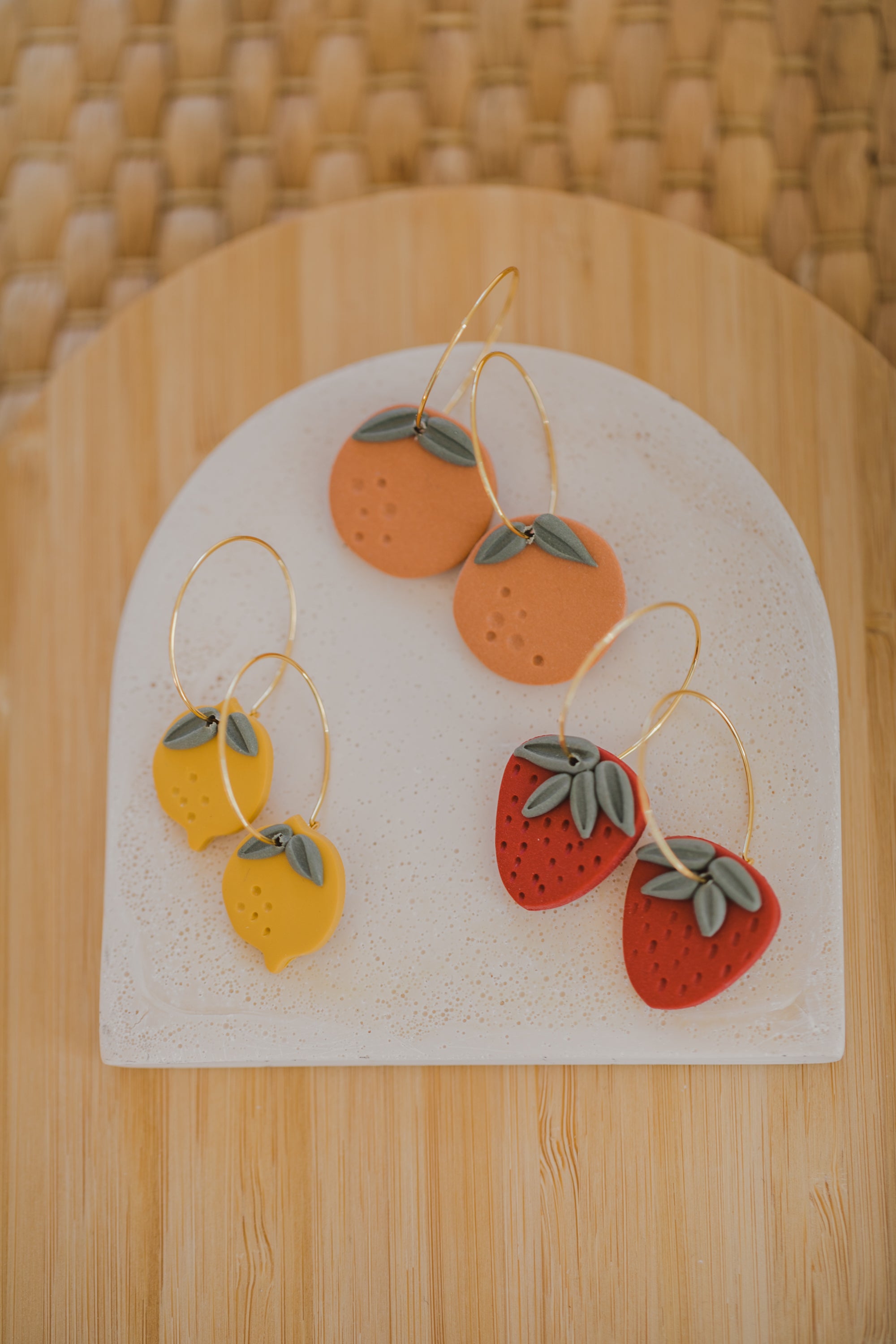 Hoop earrings with round polymer clay pendant and leaf