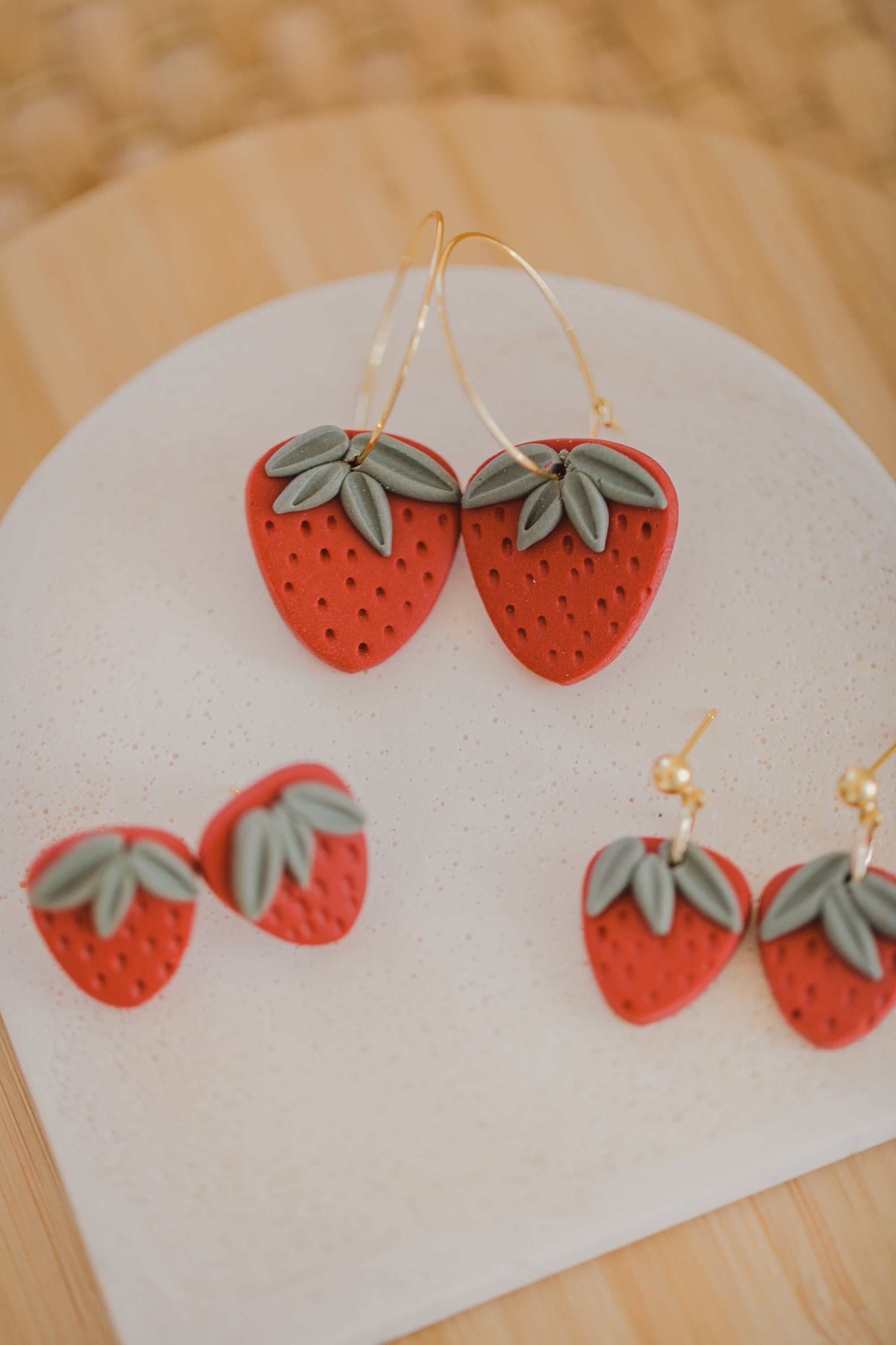 Hoop earrings with round polymer clay pendant and leaf