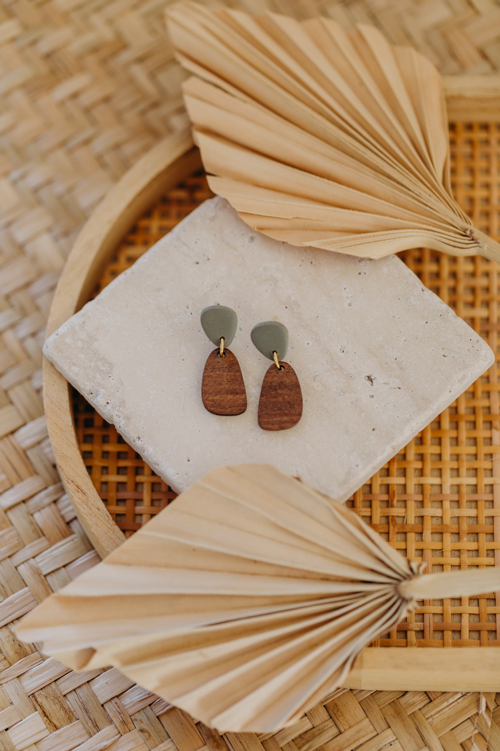 triangular polymer clay earrings in eucalyptus green with rectangular wooden pendant