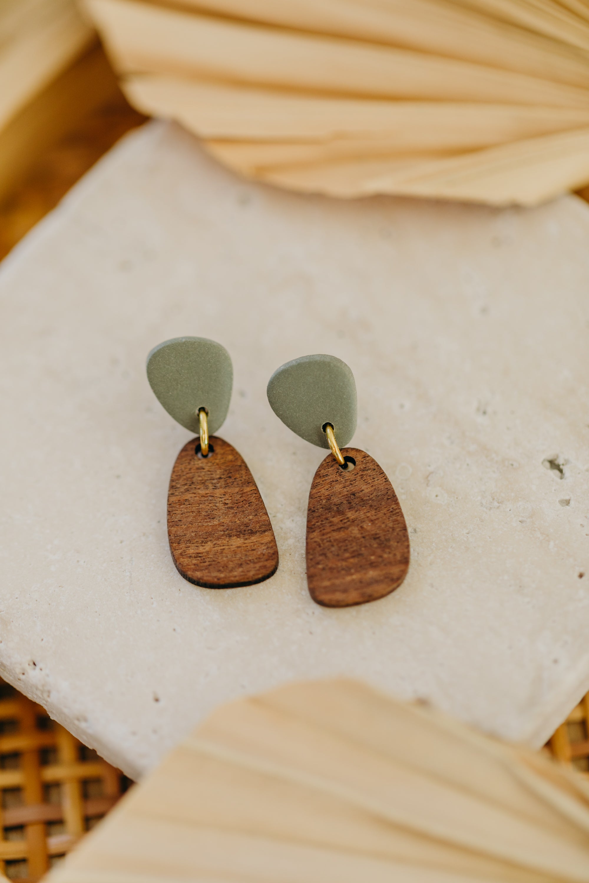 triangular polymer clay earrings in eucalyptus green with rectangular wooden pendant