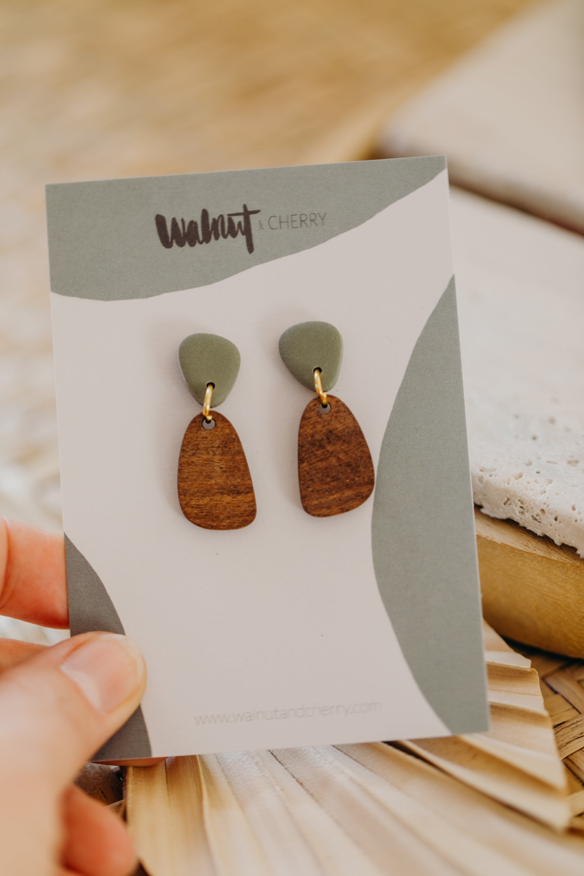 triangular polymer clay earrings in eucalyptus green with rectangular wooden pendant