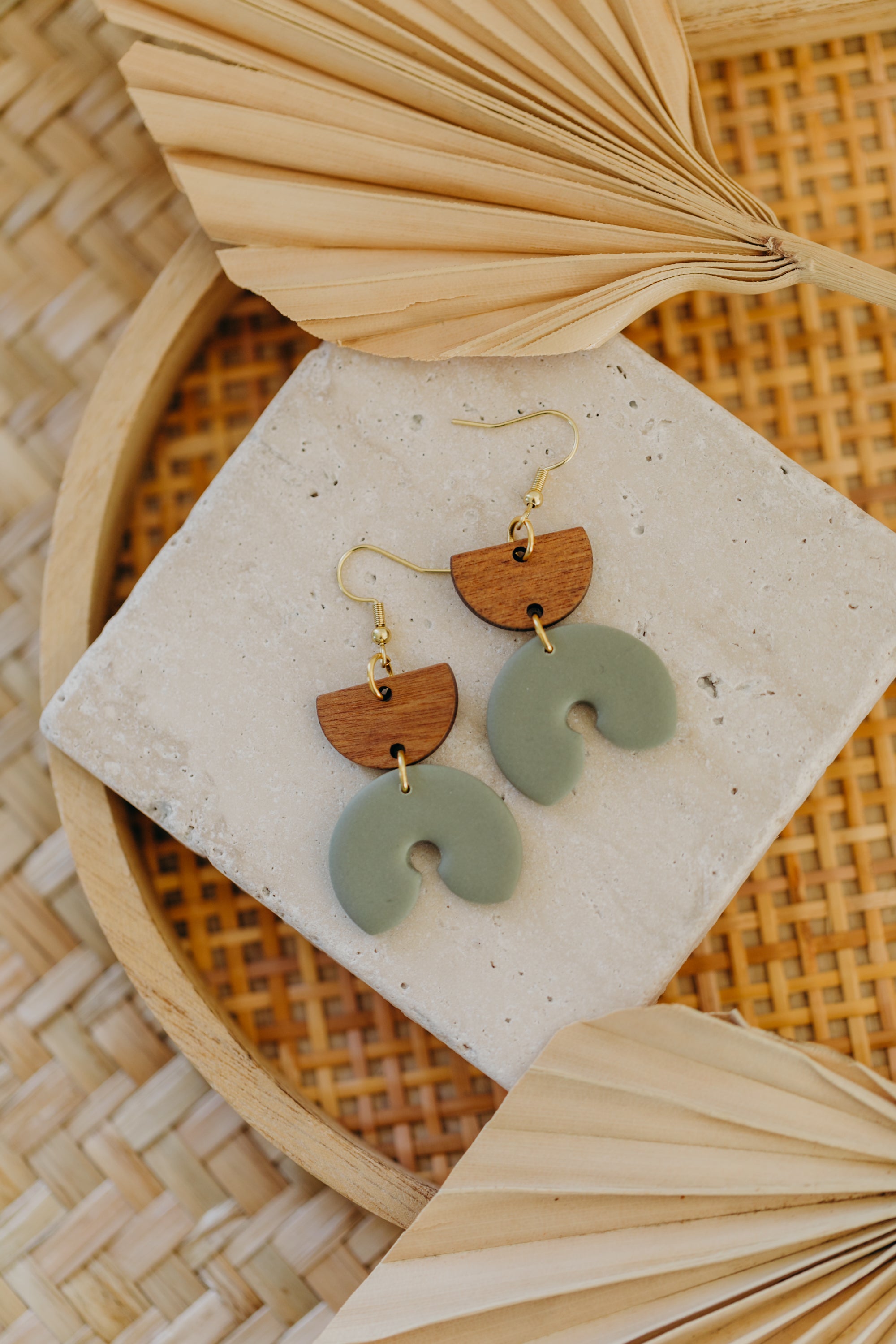 triangular polymer clay earrings in eucalyptus green with rectangular wooden pendant