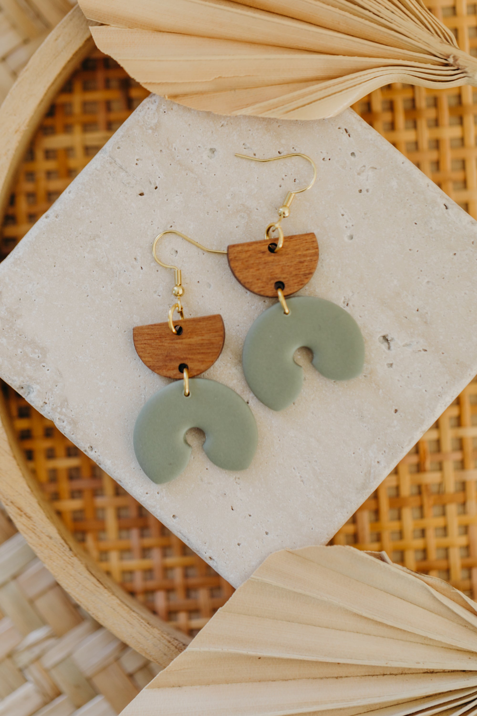 triangular polymer clay earrings in eucalyptus green with rectangular wooden pendant