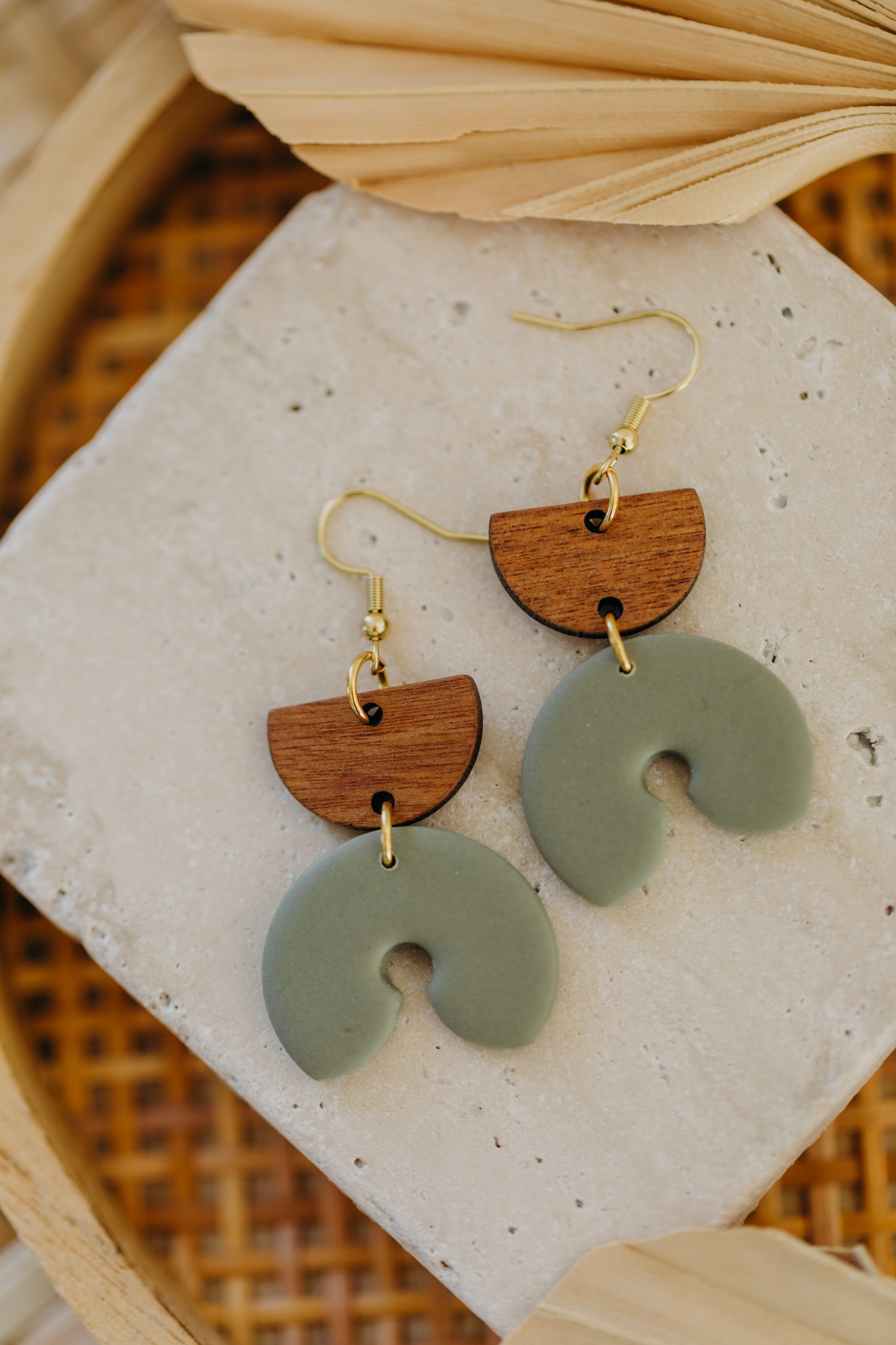 triangular polymer clay earrings in eucalyptus green with rectangular wooden pendant