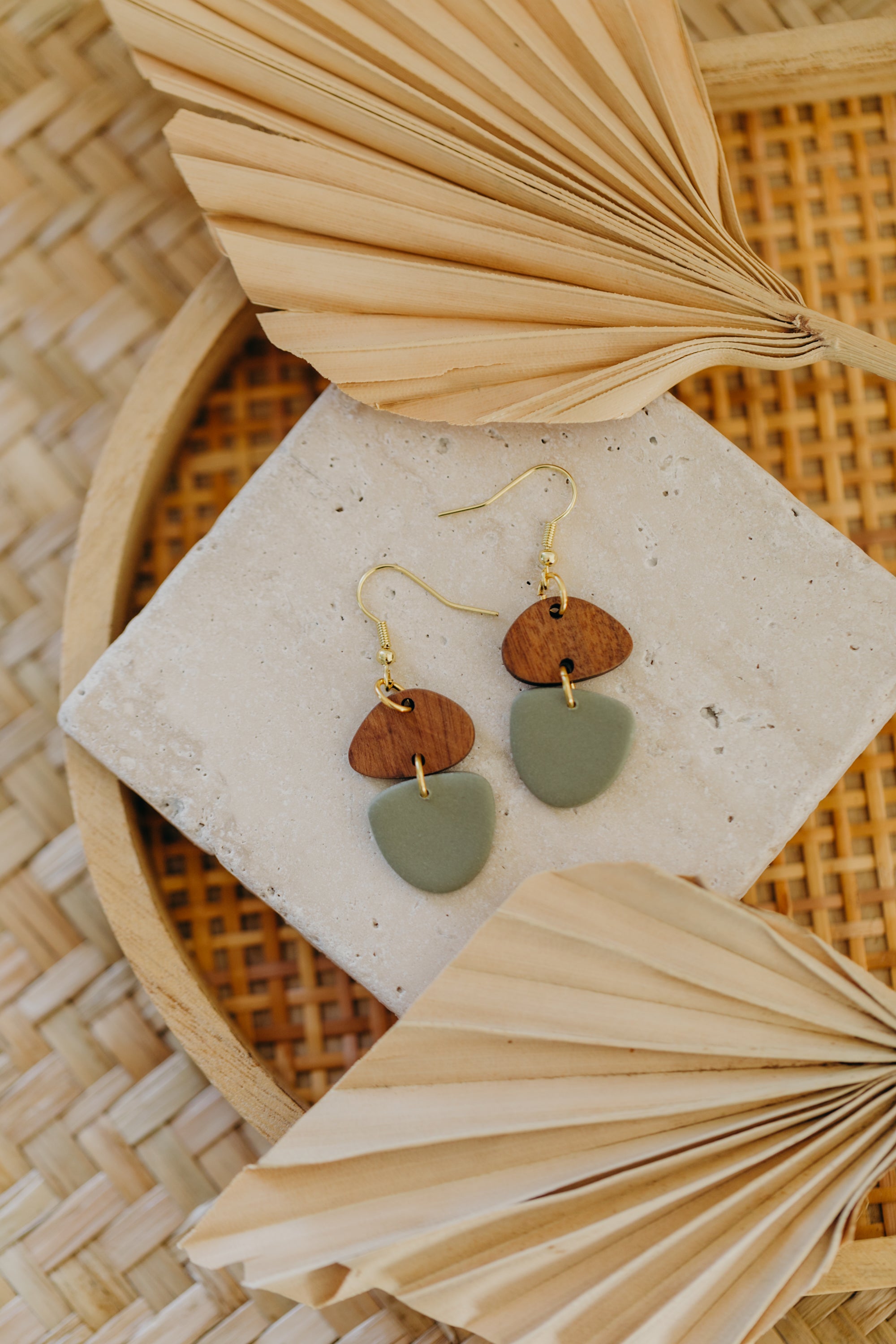 triangular polymer clay earrings in eucalyptus green with rectangular wooden pendant