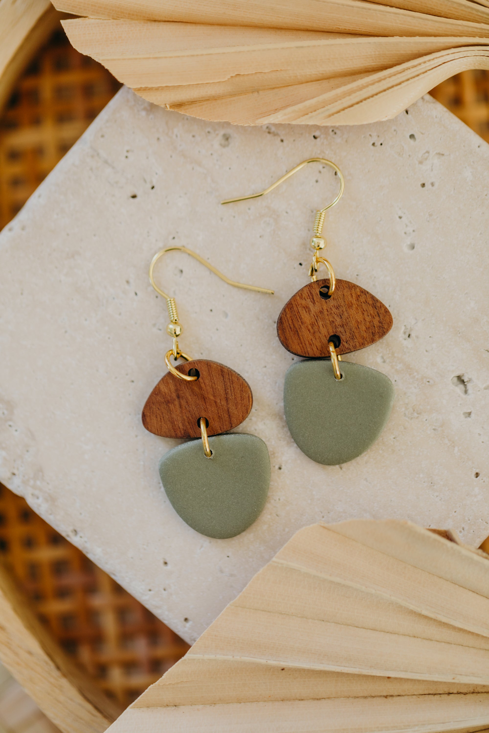 triangular polymer clay earrings in eucalyptus green with rectangular wooden pendant