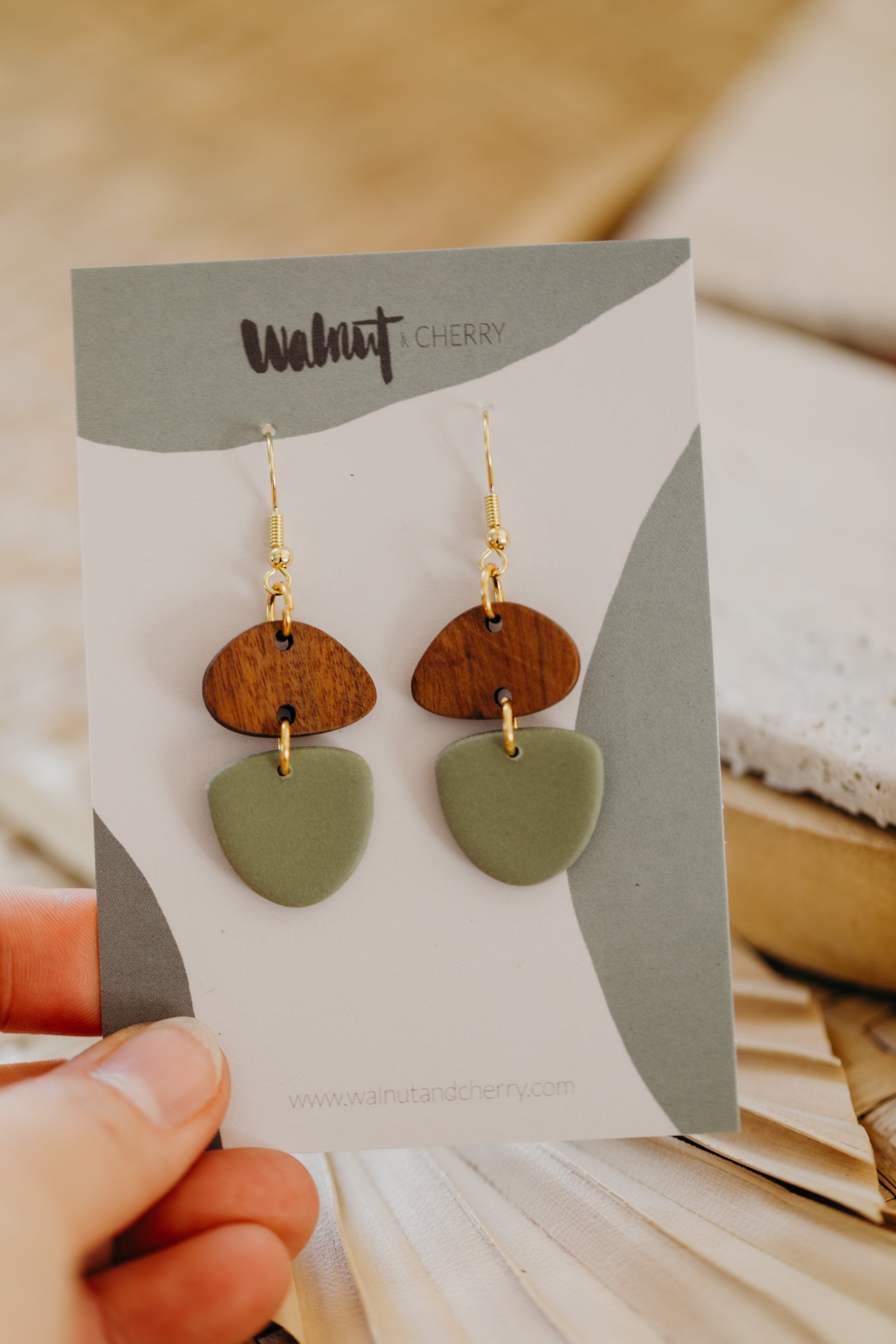 triangular polymer clay earrings in eucalyptus green with rectangular wooden pendant