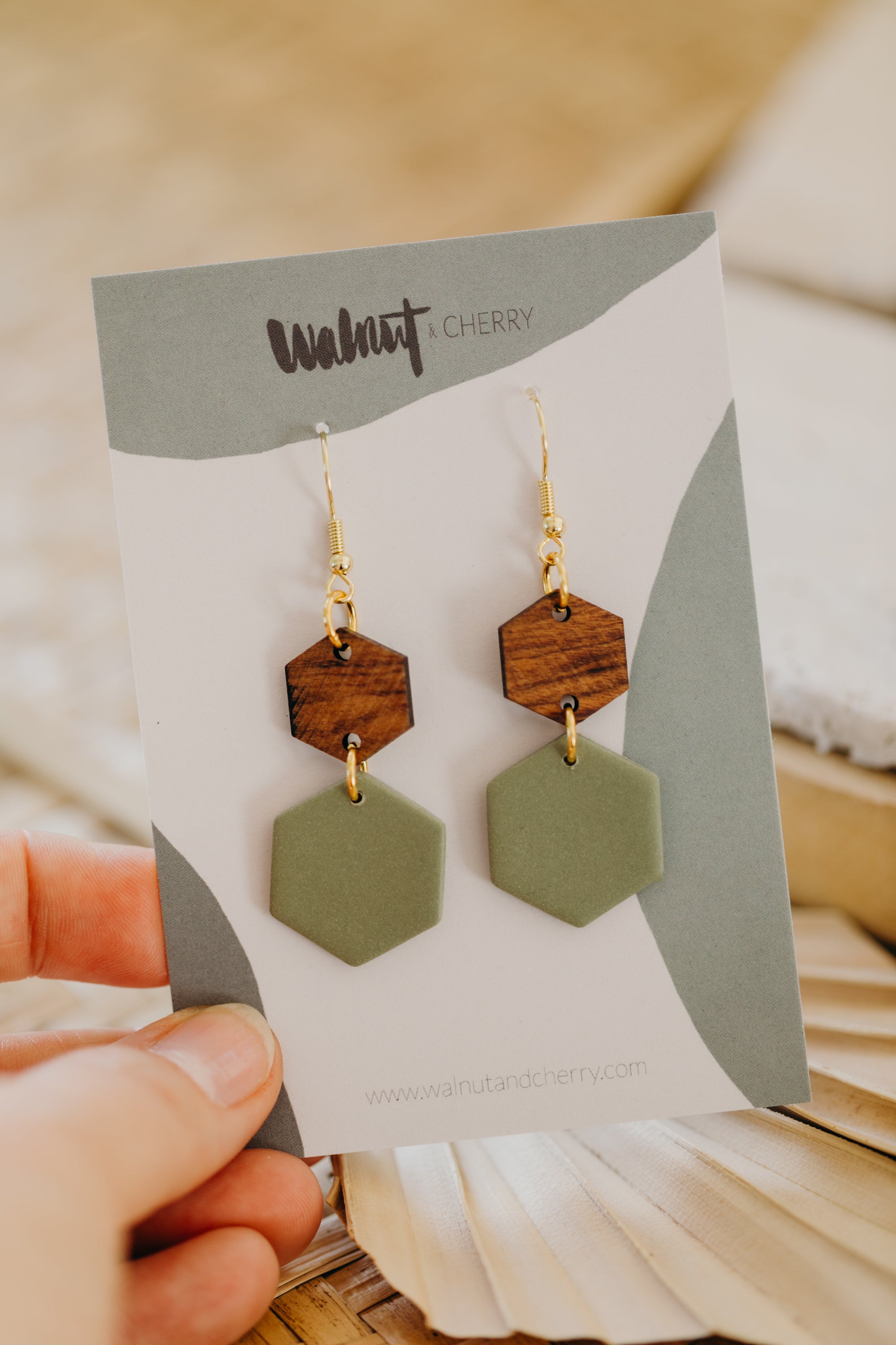 triangular polymer clay earrings in eucalyptus green with rectangular wooden pendant