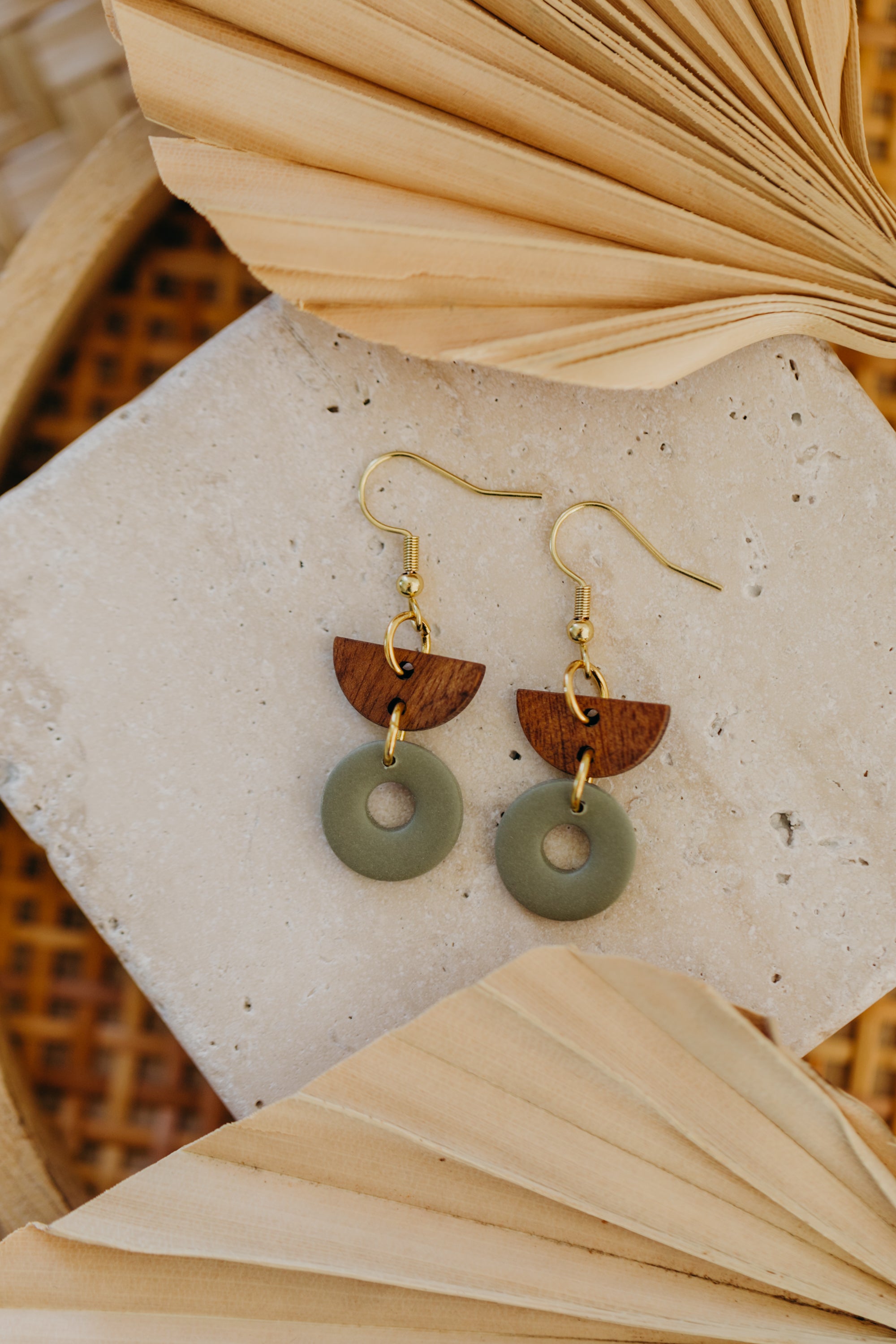 triangular polymer clay earrings in eucalyptus green with rectangular wooden pendant