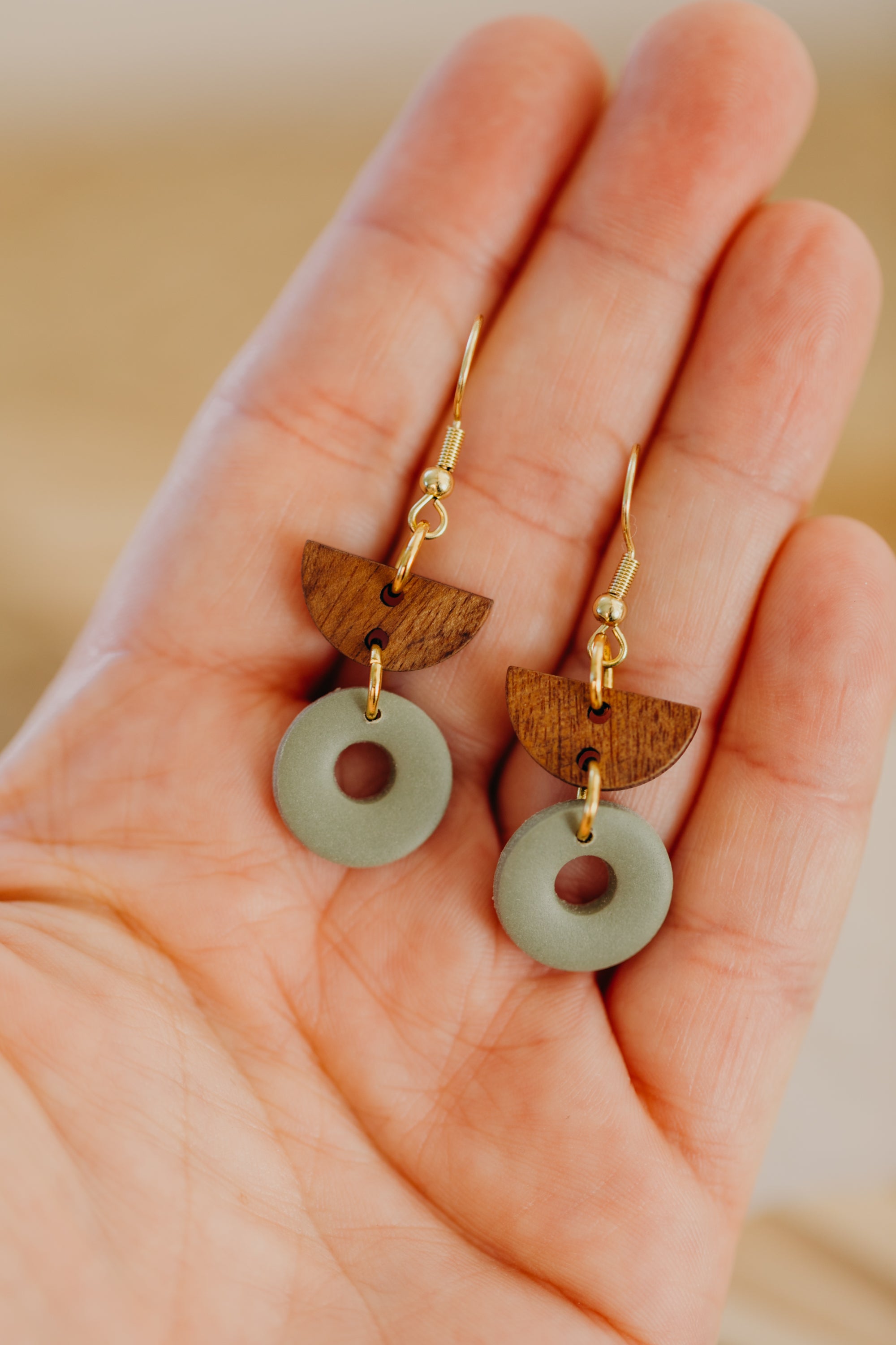 triangular polymer clay earrings in eucalyptus green with rectangular wooden pendant