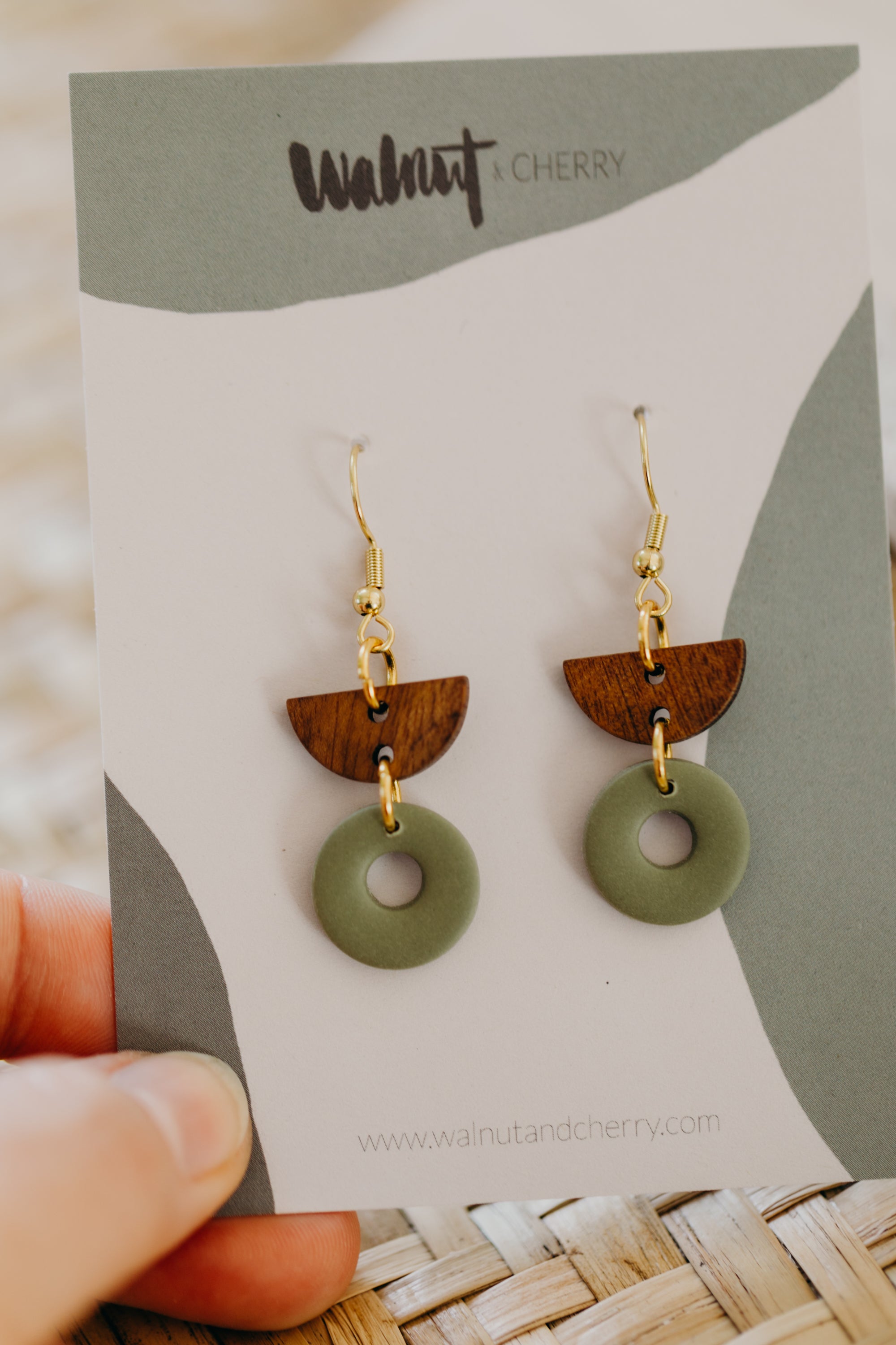 triangular polymer clay earrings in eucalyptus green with rectangular wooden pendant
