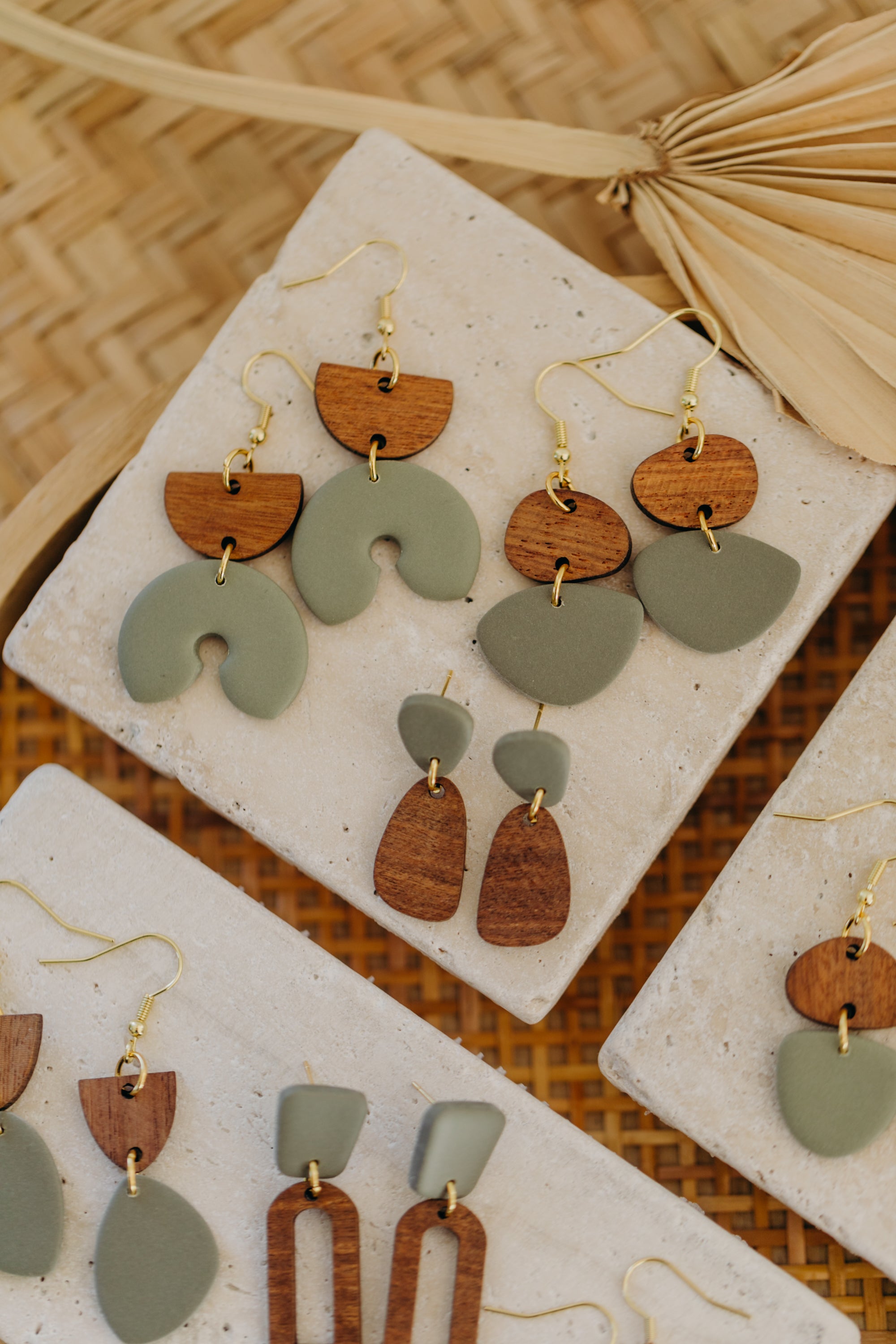 triangular polymer clay earrings in eucalyptus green with rectangular wooden pendant