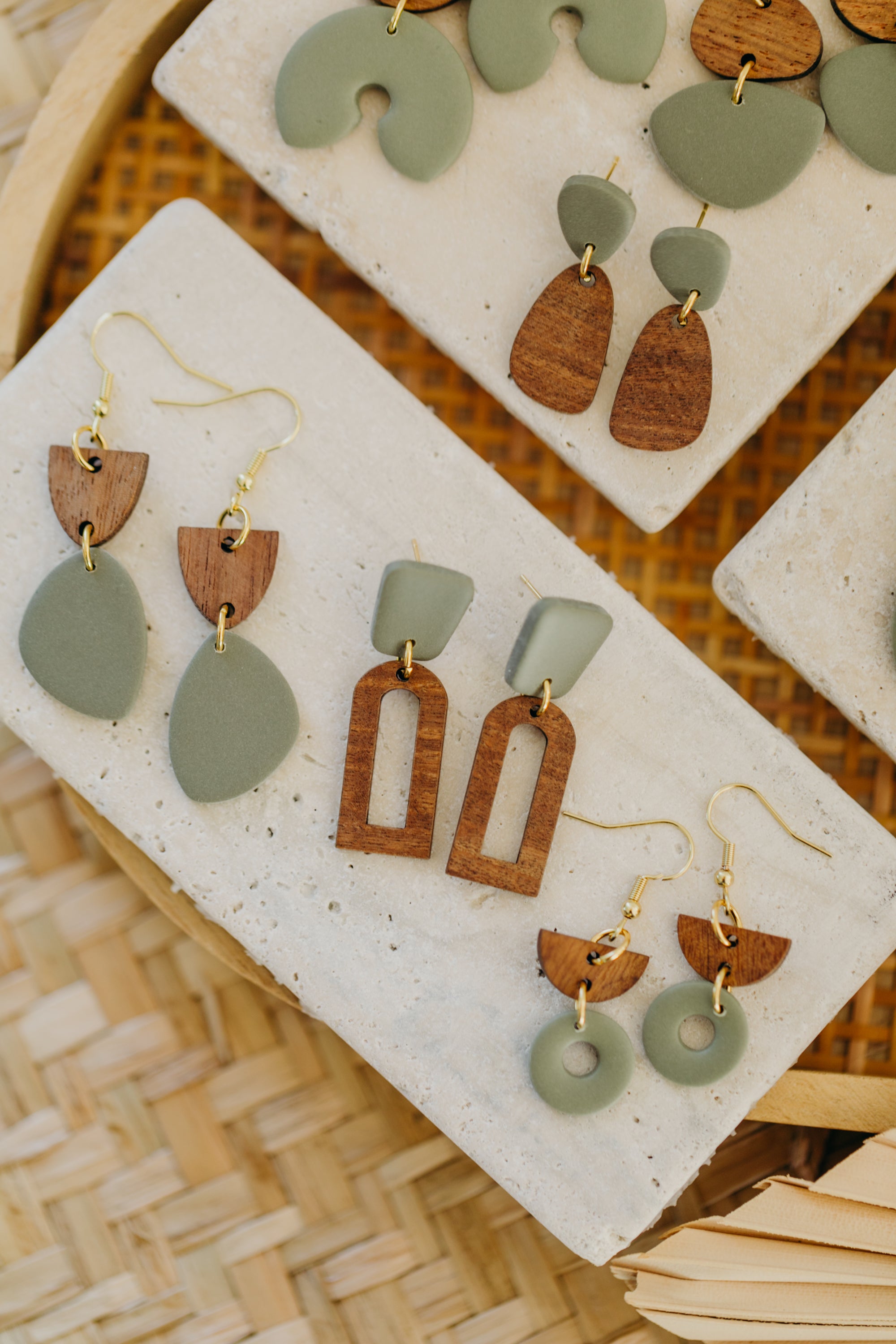 triangular polymer clay earrings in eucalyptus green with rectangular wooden pendant