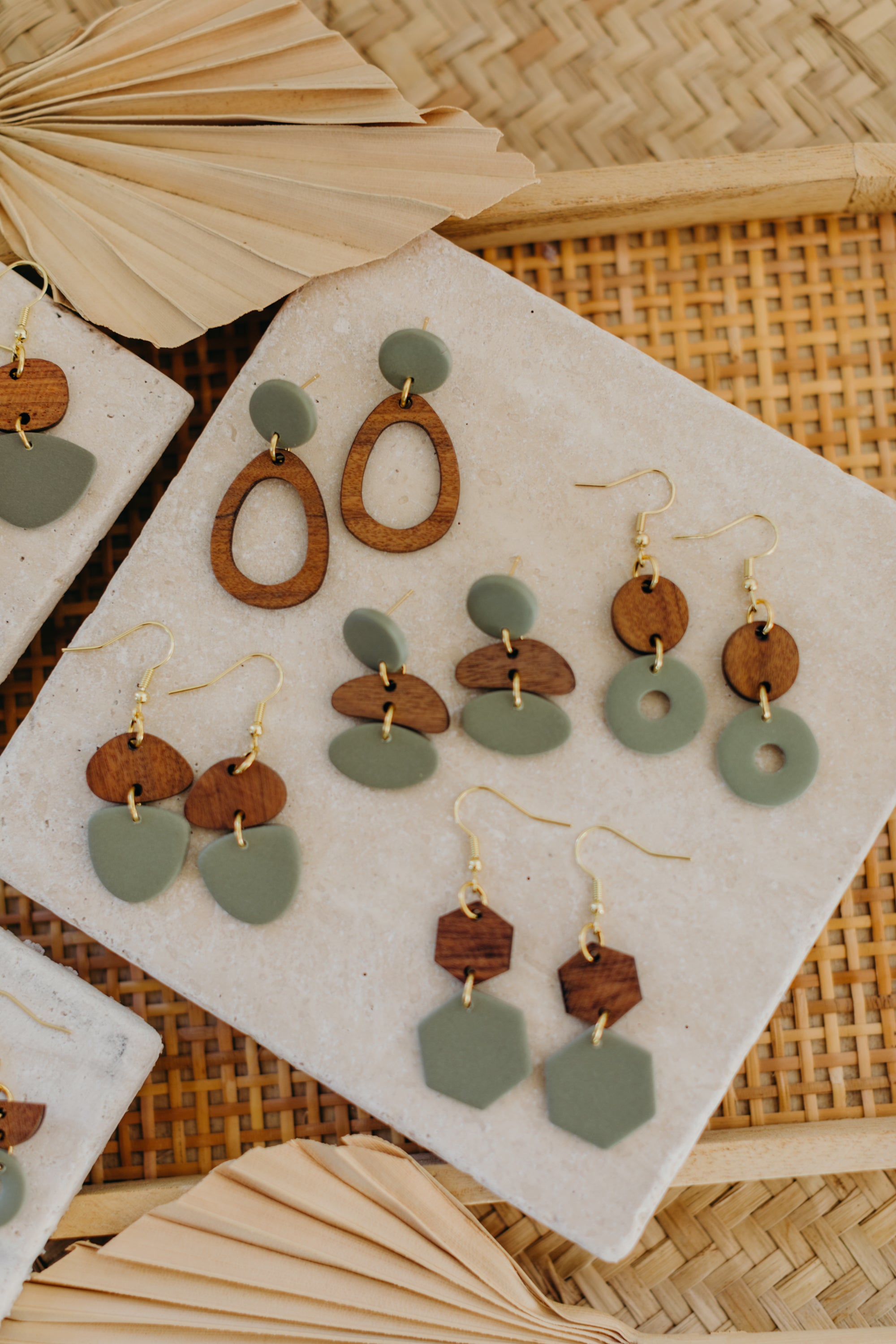 triangular polymer clay earrings in eucalyptus green with rectangular wooden pendant