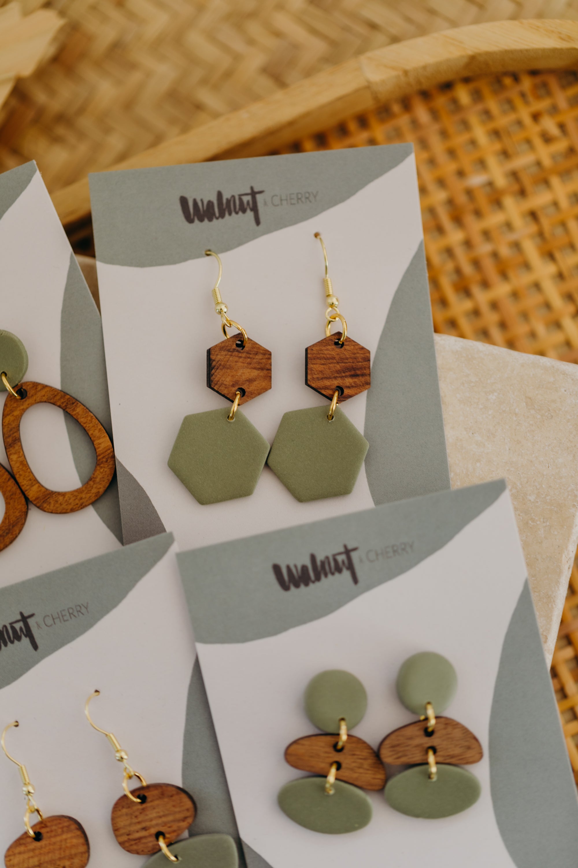 triangular polymer clay earrings in eucalyptus green with rectangular wooden pendant