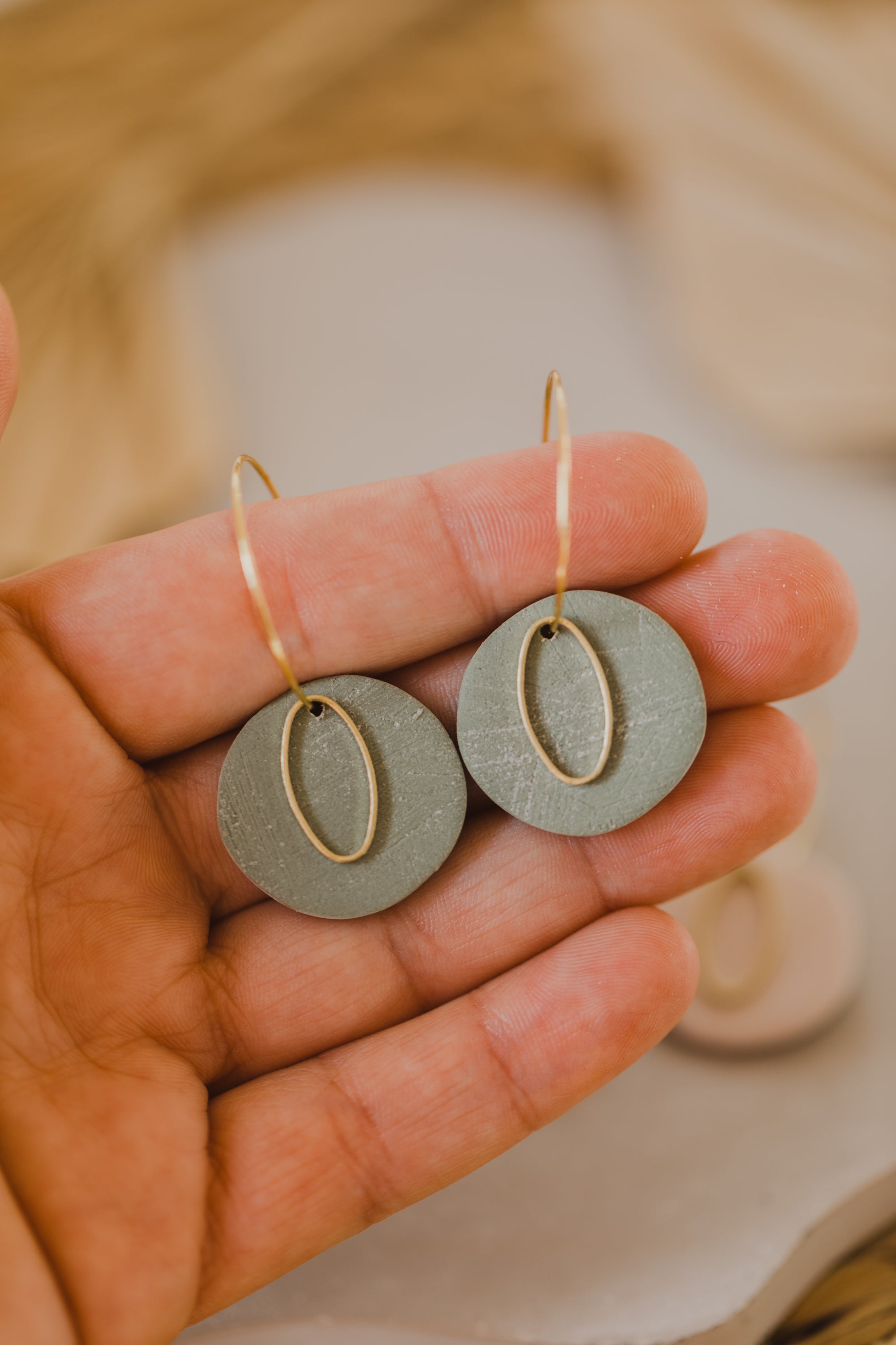 Hoop earrings with round polymer clay pendant and leaf