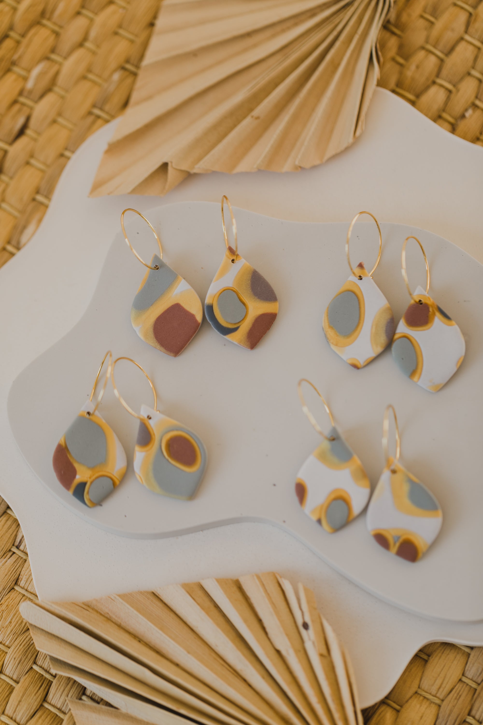 golden earrings with acrylic in white, petrol and brown