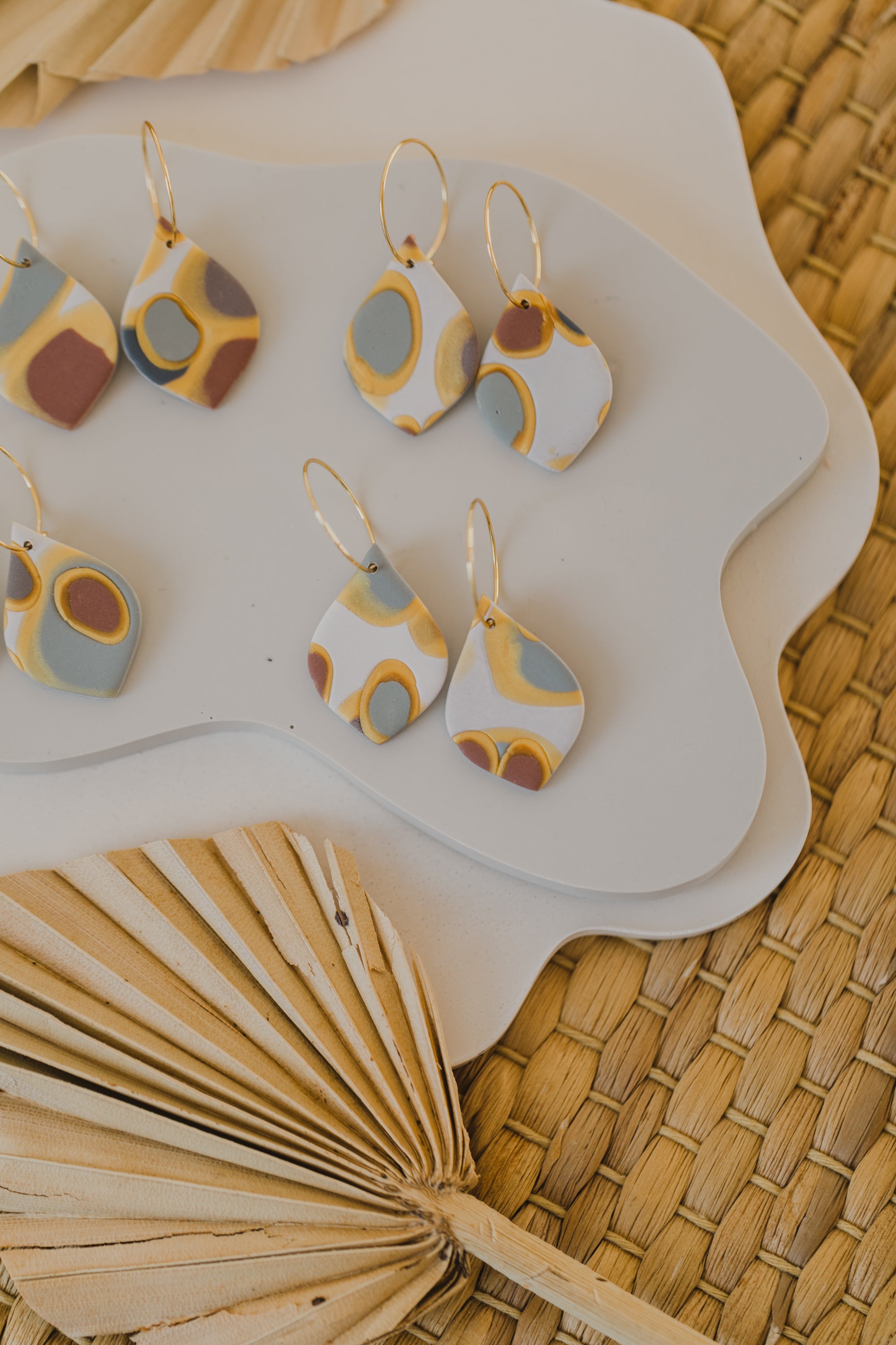 golden earrings with acrylic in white, petrol and brown