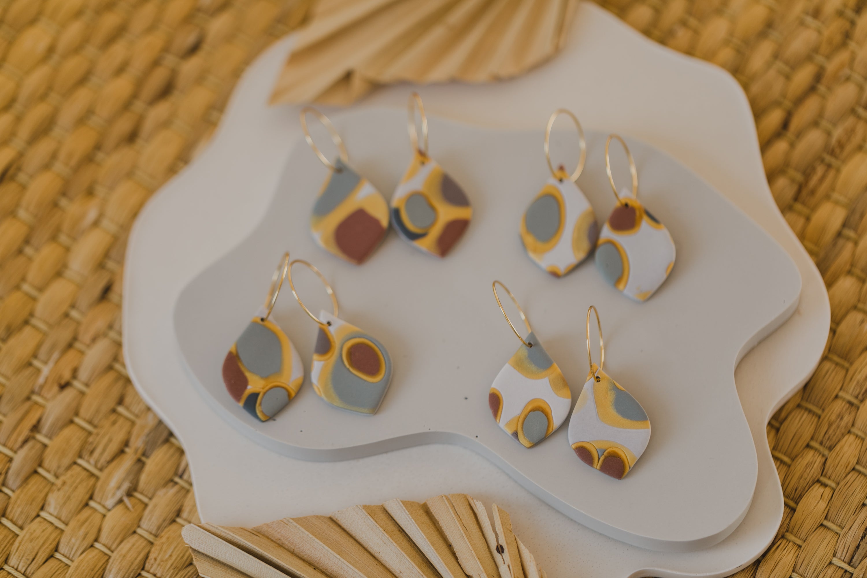 golden earrings with acrylic in white, petrol and brown