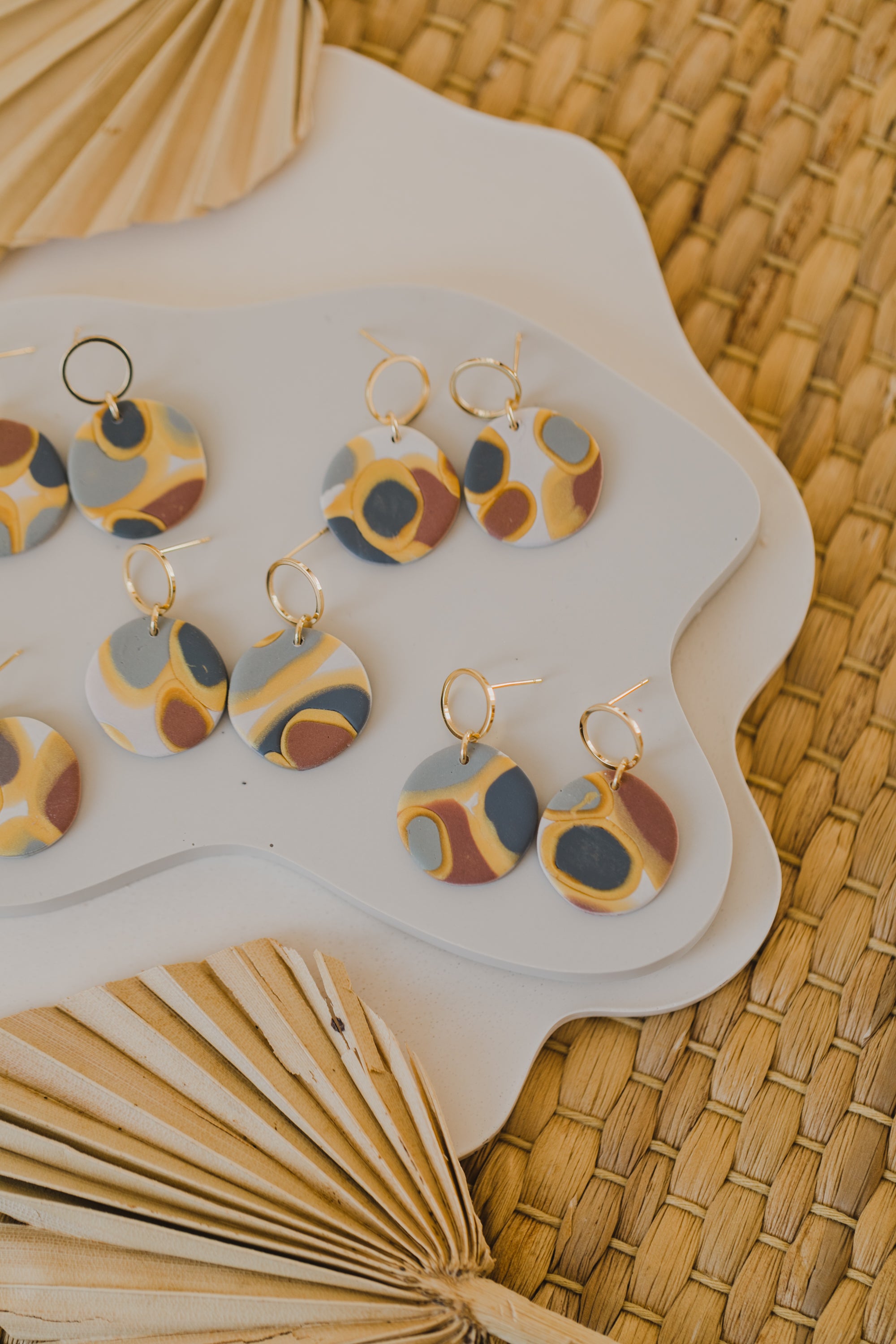 golden earrings with acrylic in white, petrol and brown