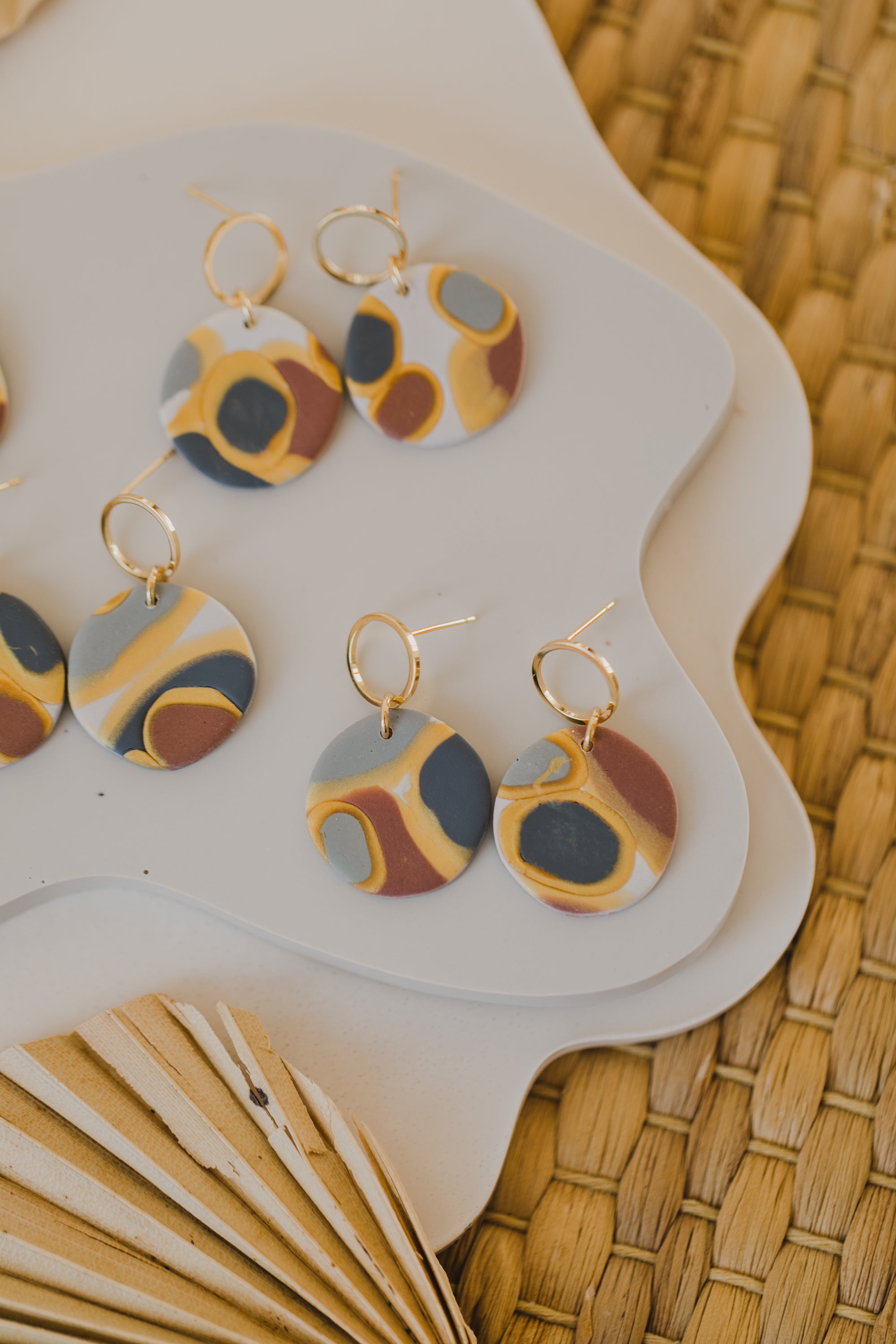 golden earrings with acrylic in white, petrol and brown