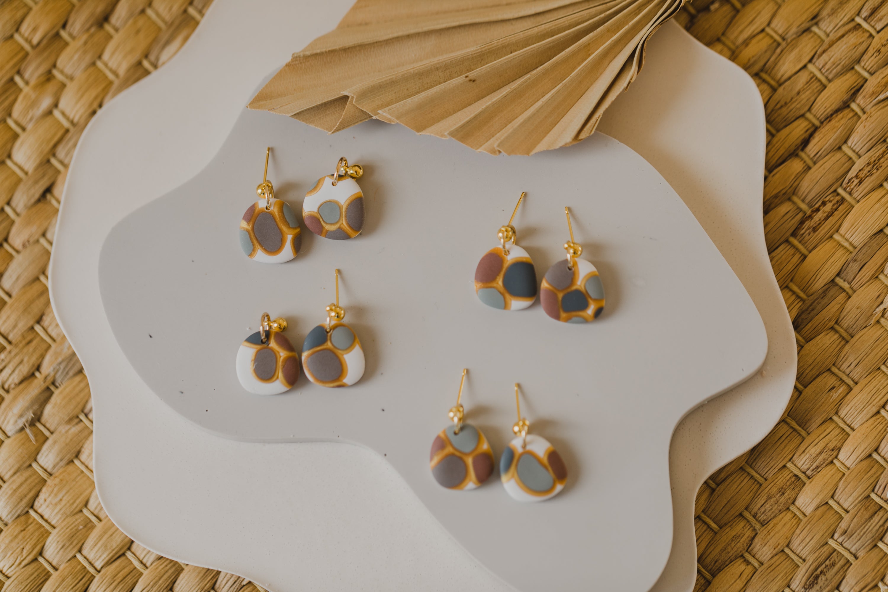 golden earrings with acrylic in white, petrol and brown