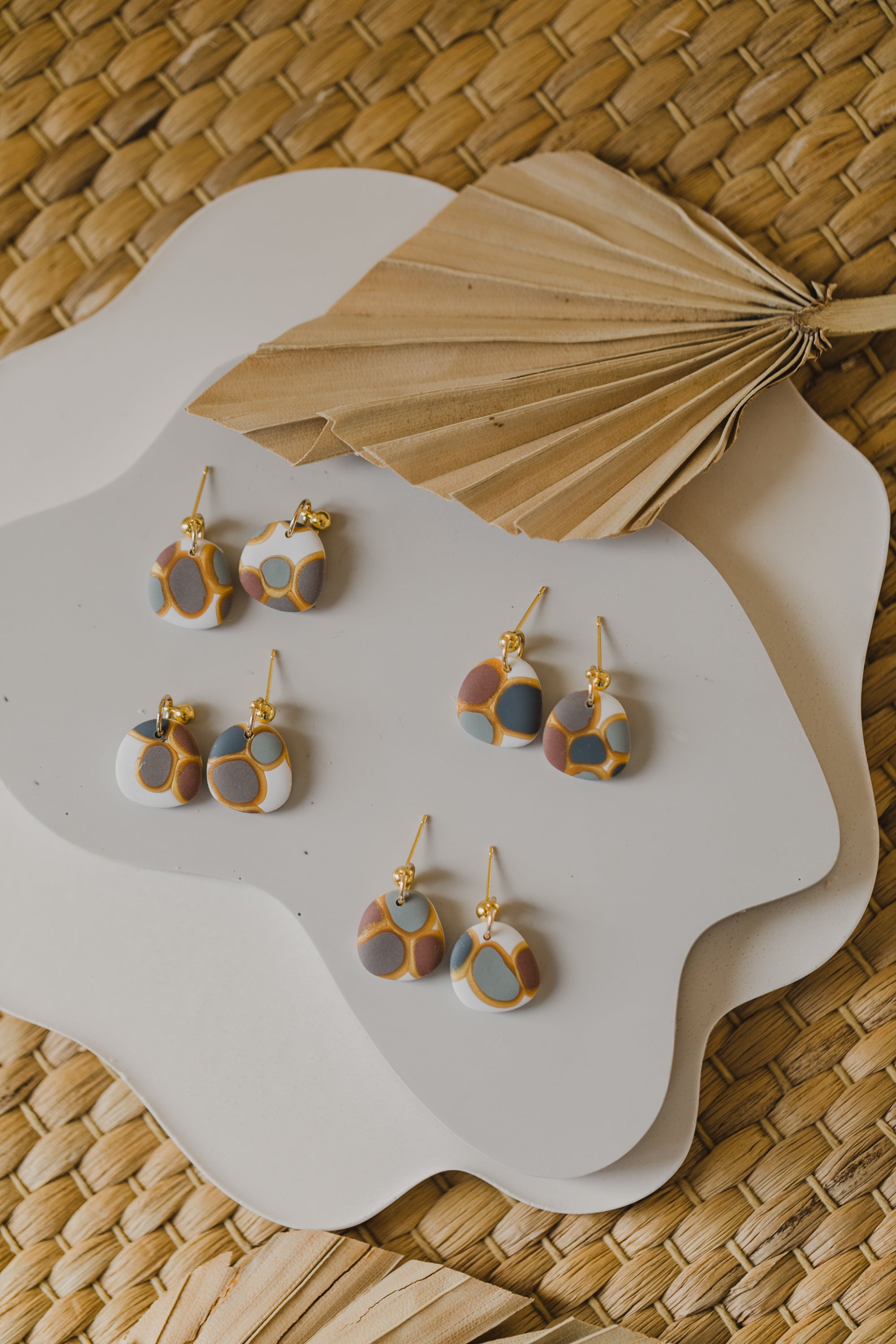 golden earrings with acrylic in white, petrol and brown