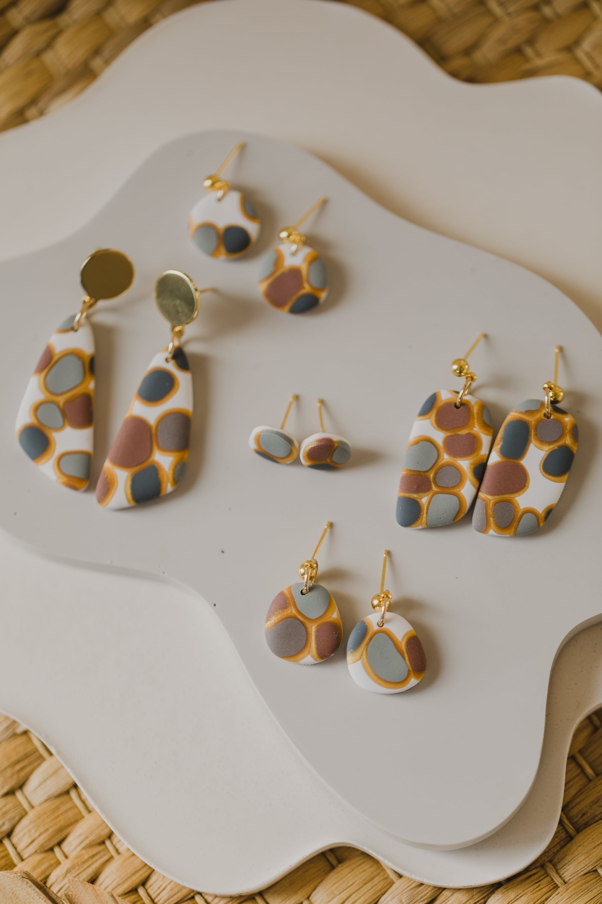 golden earrings with acrylic in white, petrol and brown