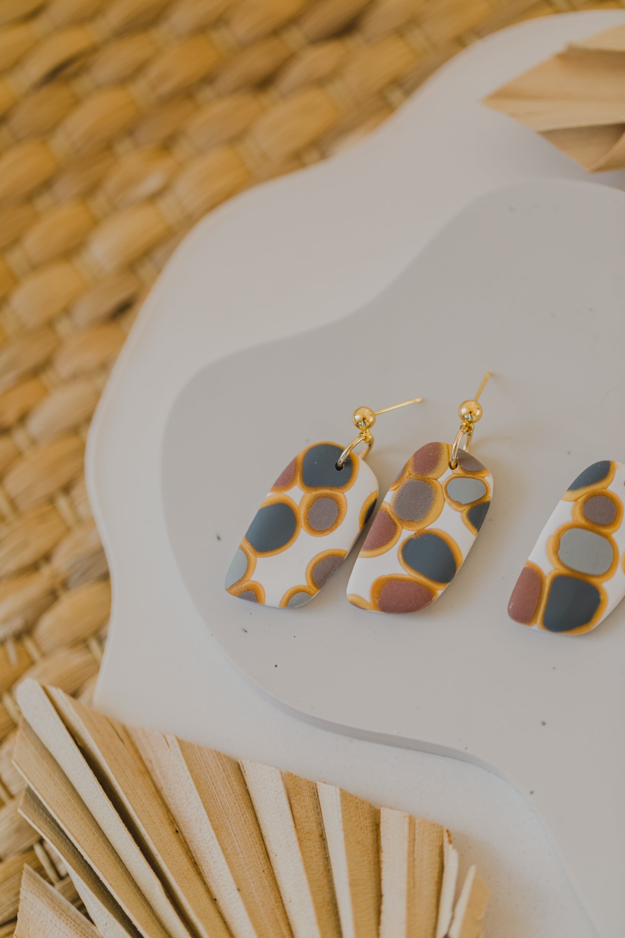 golden earrings with acrylic in white, petrol and brown