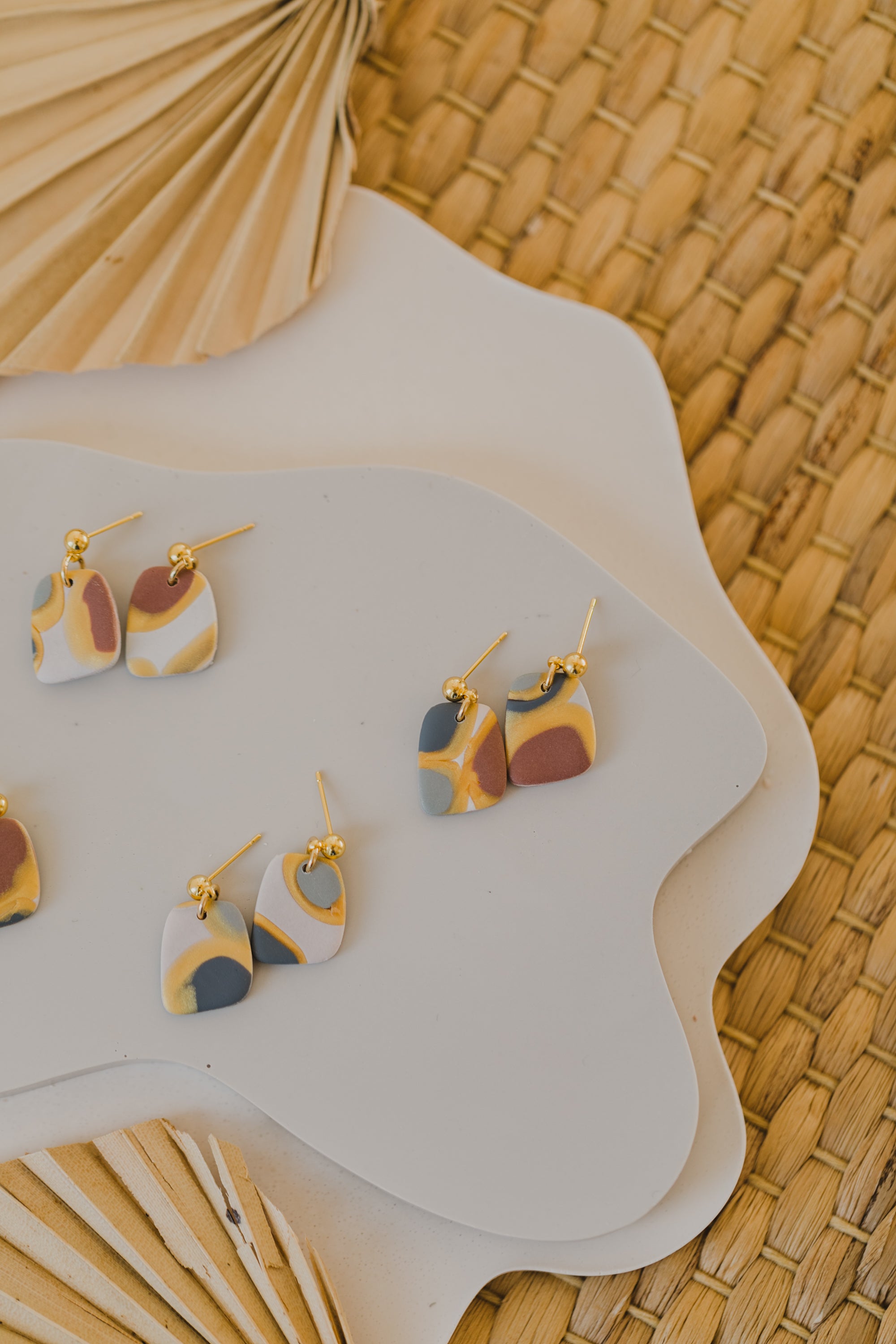 golden earrings with acrylic in white, petrol and brown