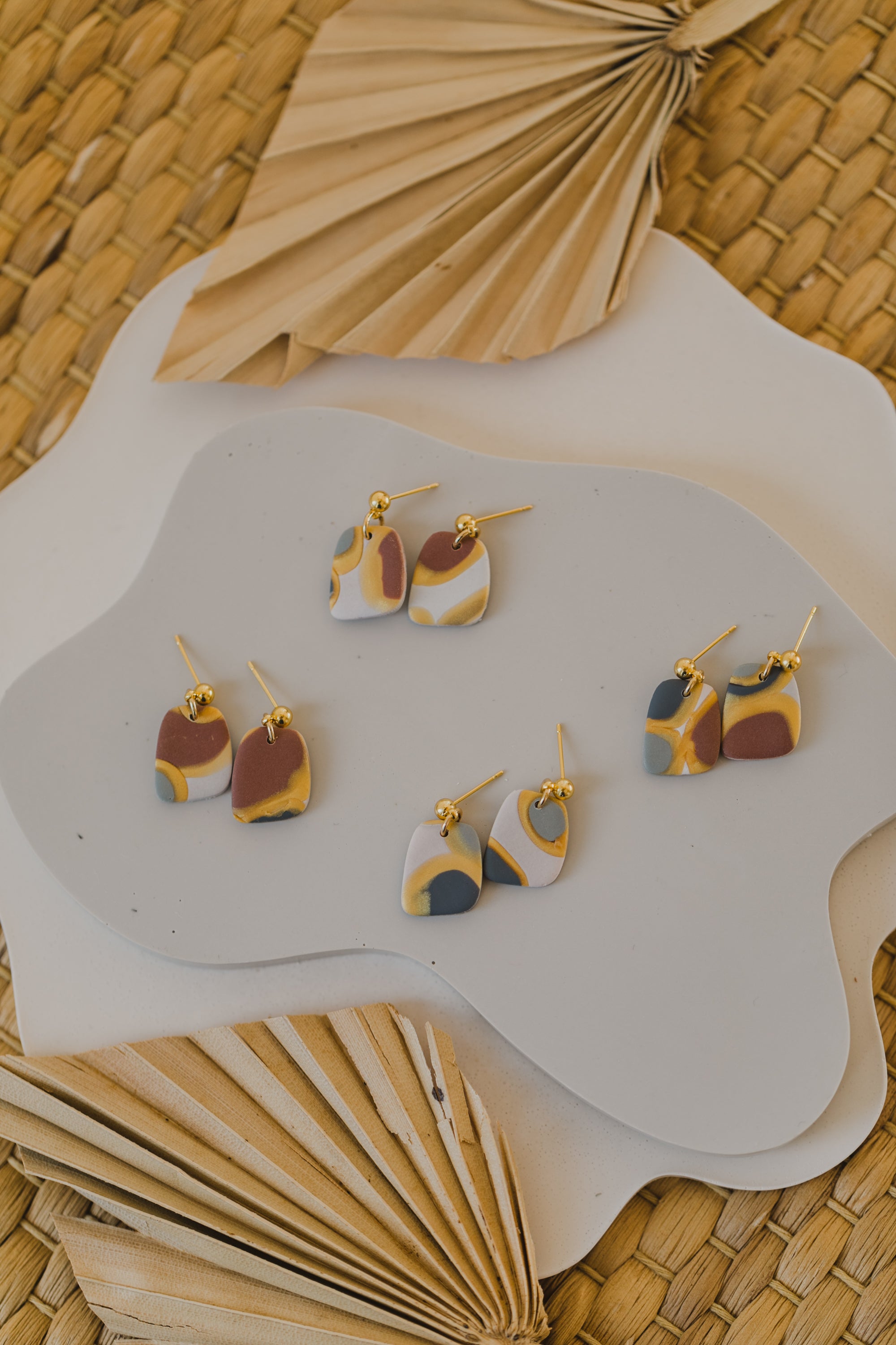 golden earrings with acrylic in white, petrol and brown
