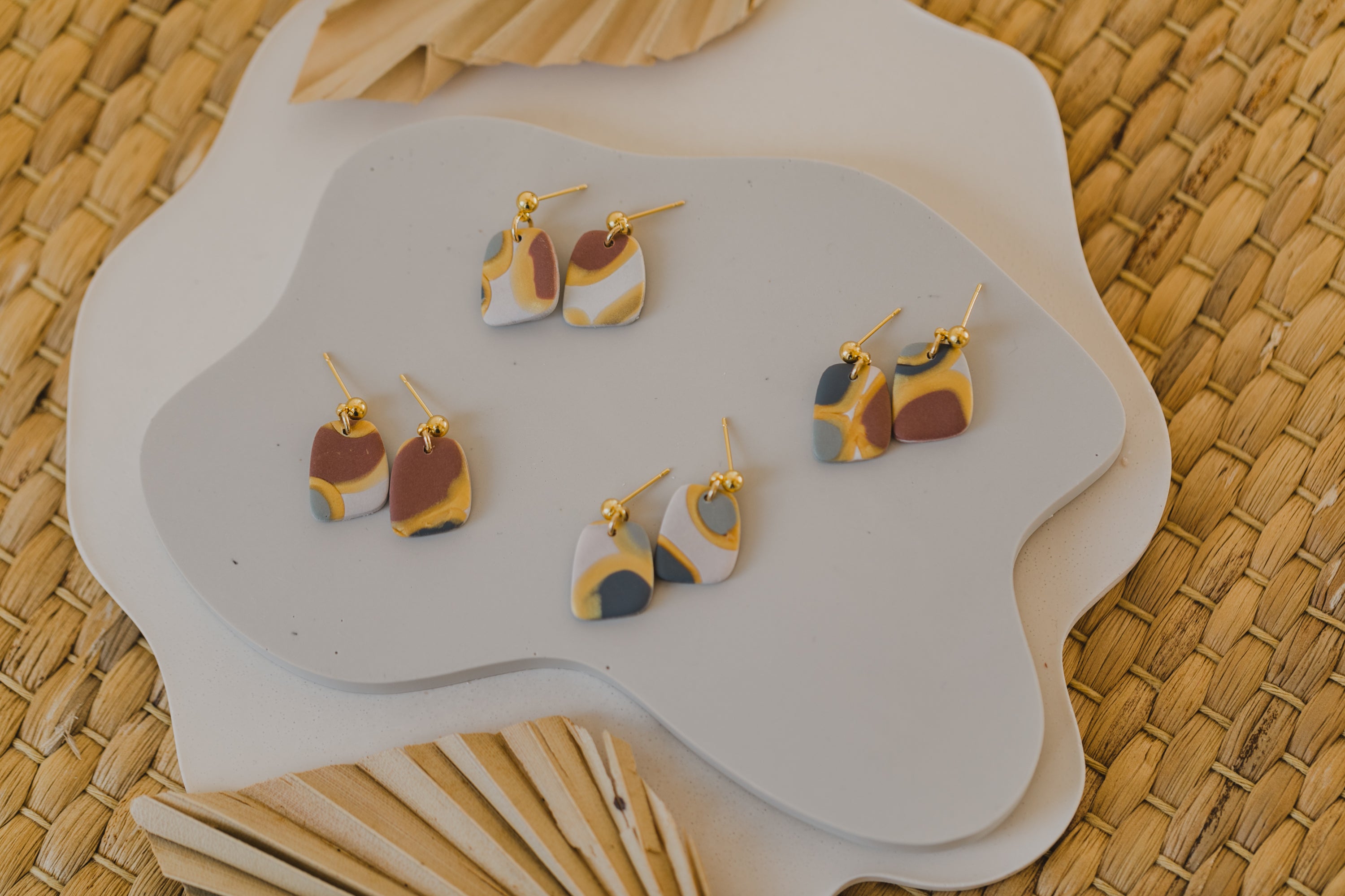 golden earrings with acrylic in white, petrol and brown
