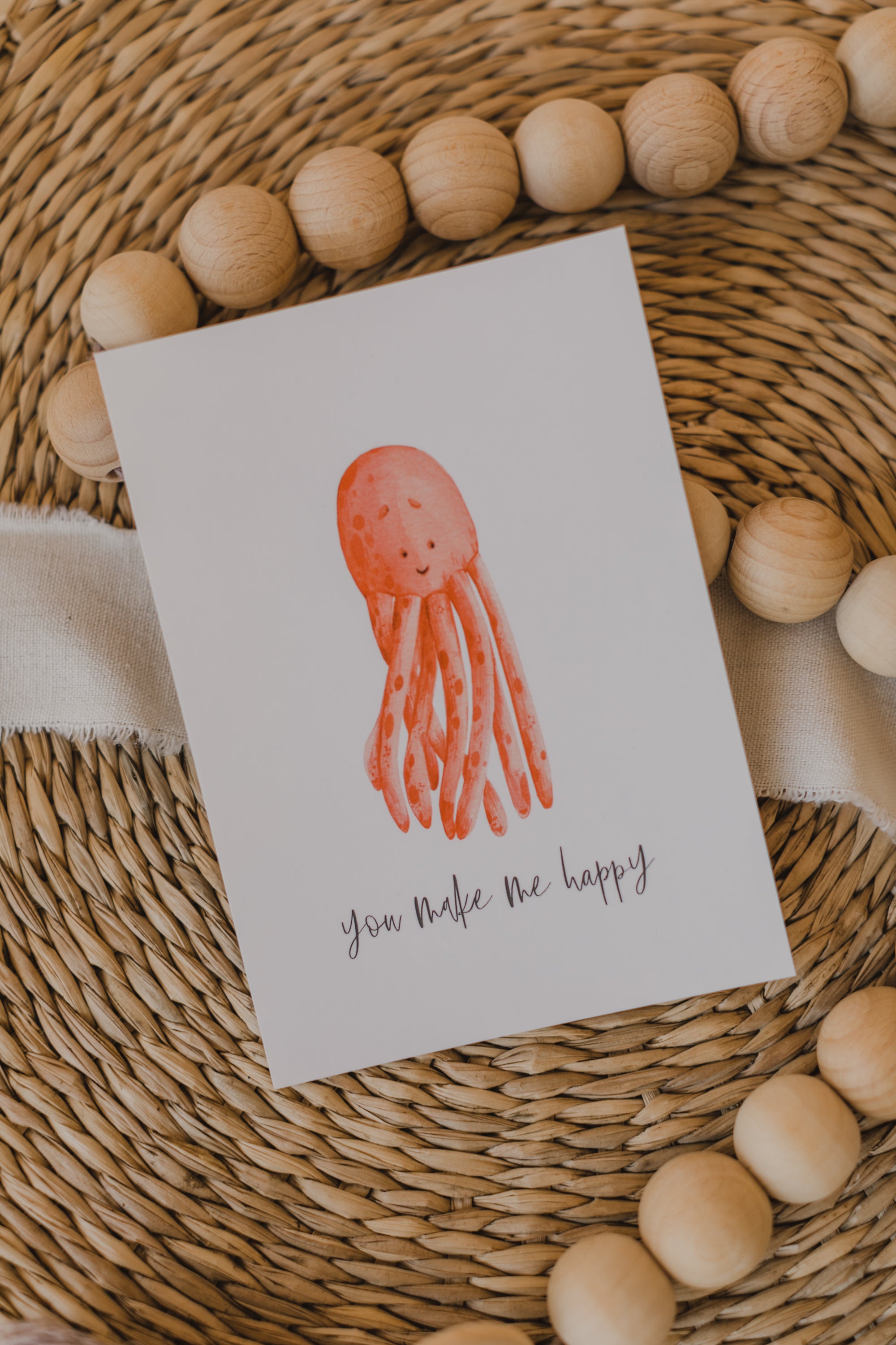 Postkarte roter Oktopus mit dem Aufdruck "you make me happy"