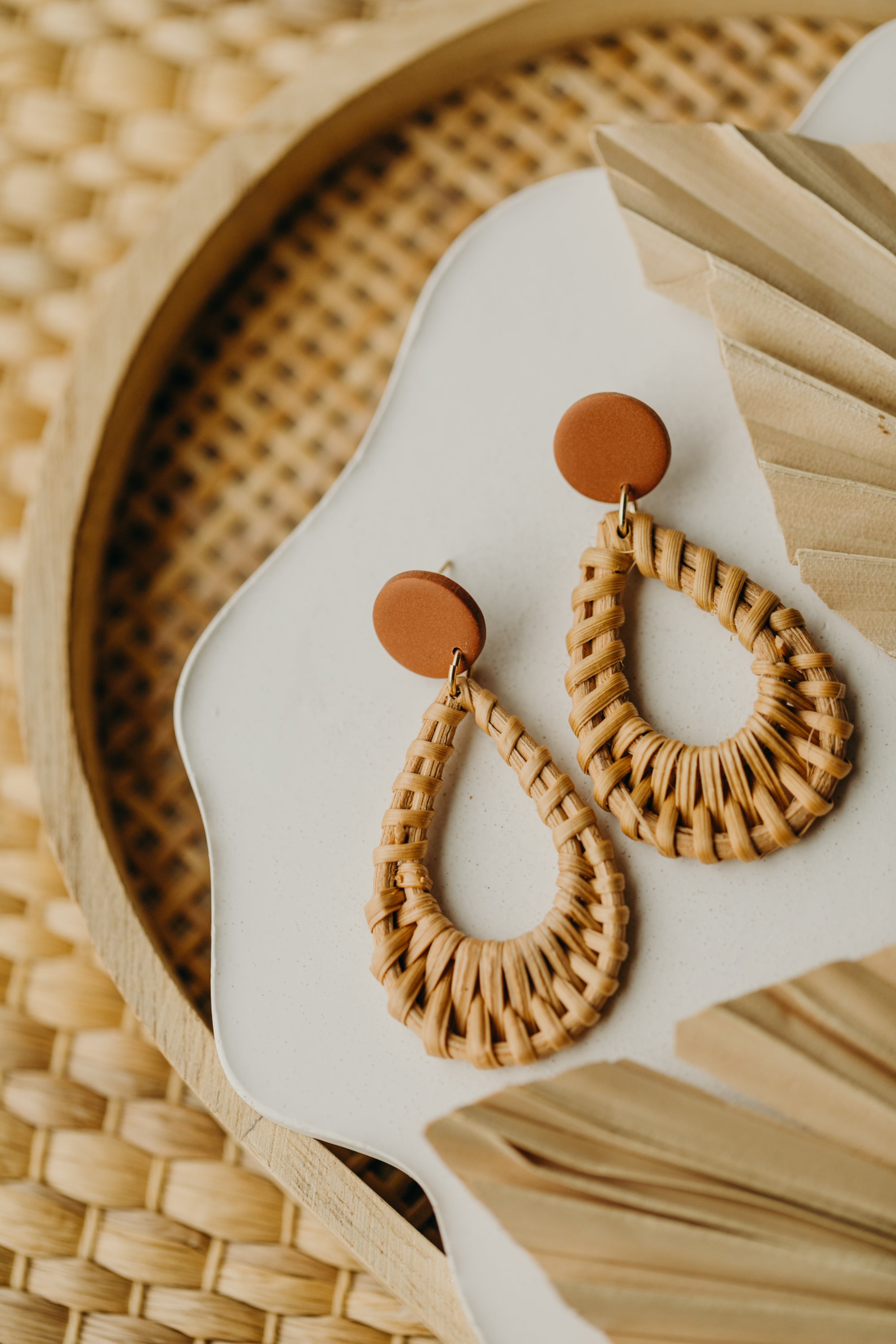 round polymer clay earrings in the color cinnamon with rattan pendant drops