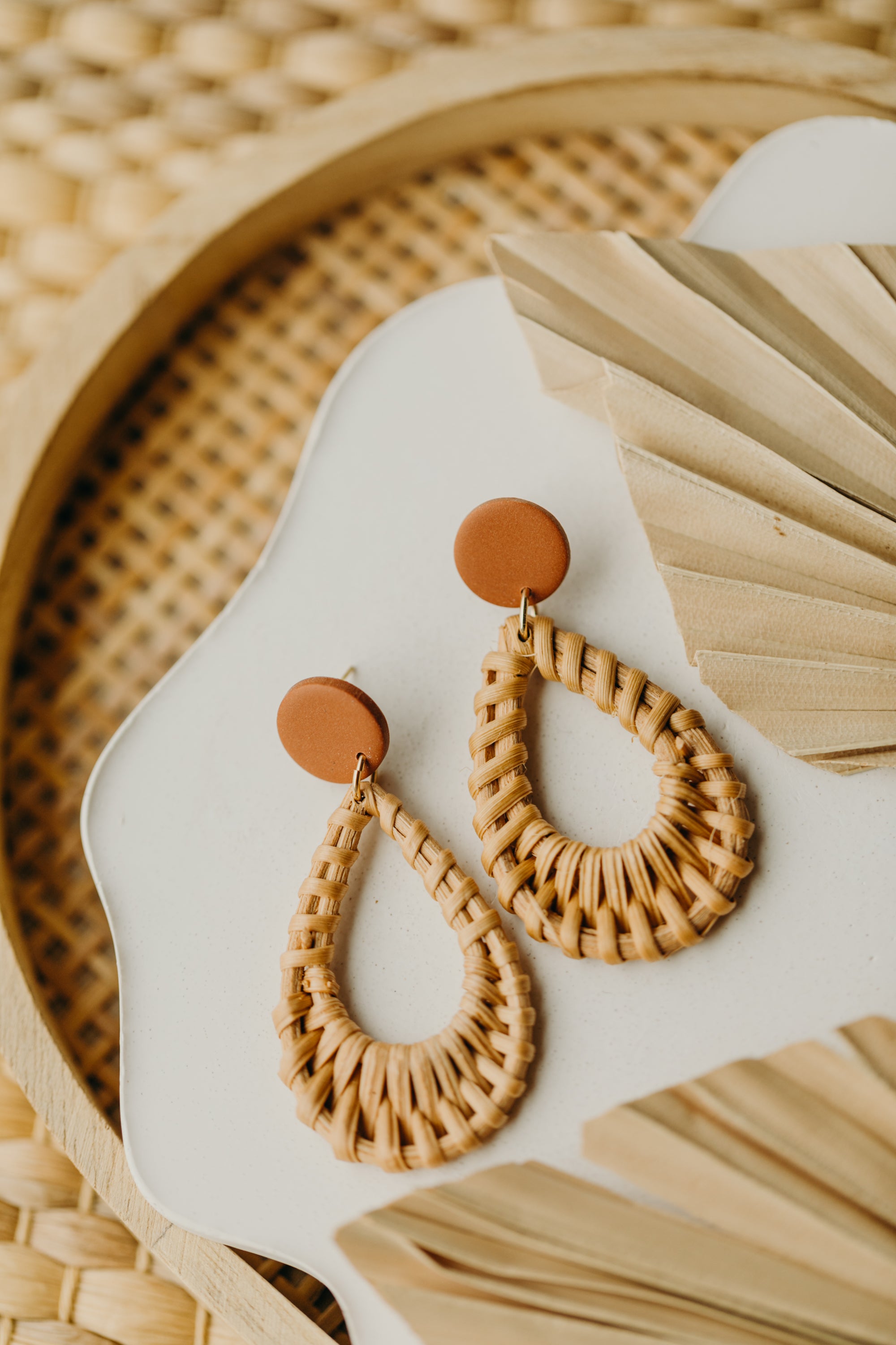 round polymer clay earrings in the color cinnamon with rattan pendant drops