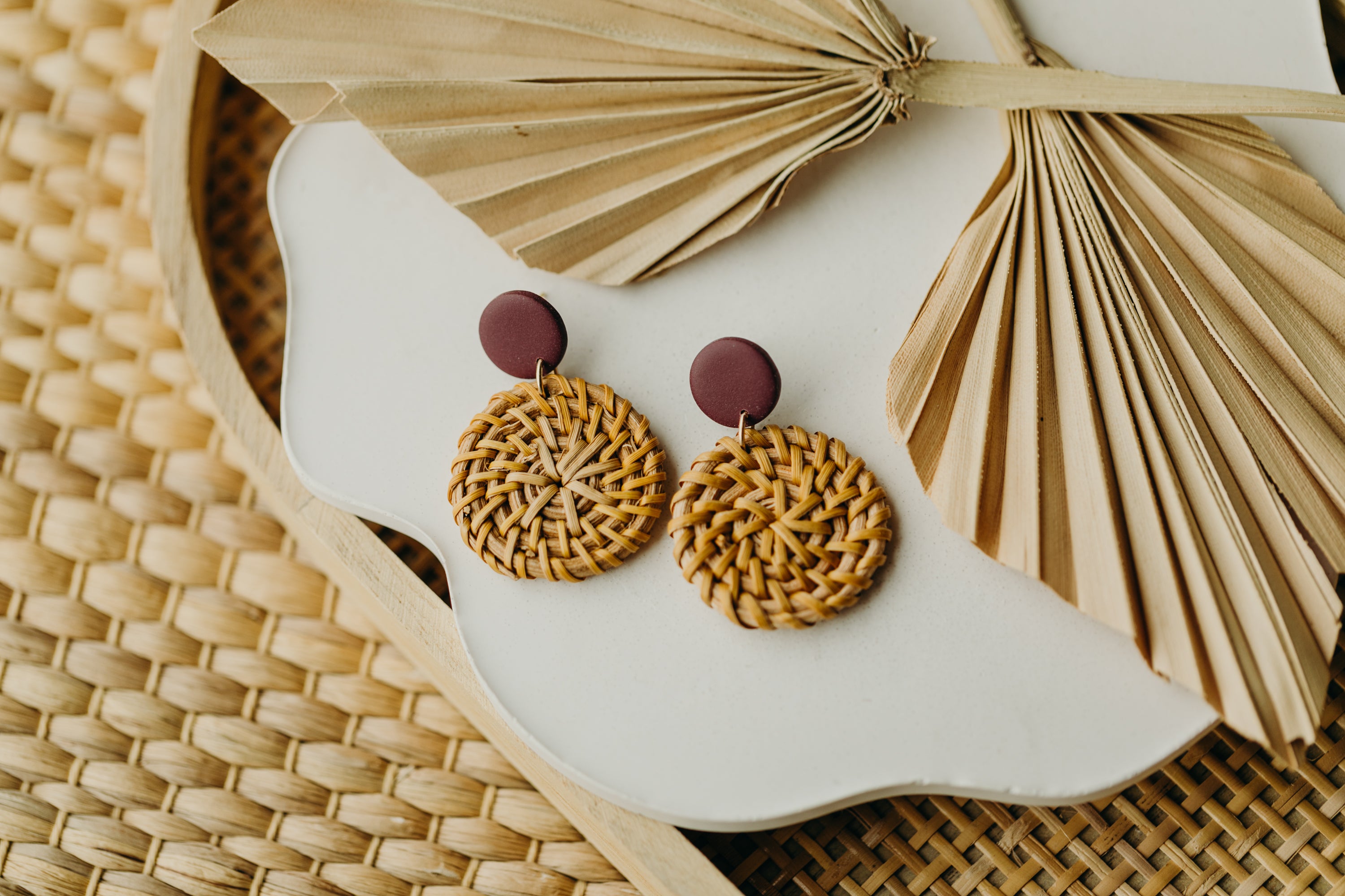 Polymer clay earrings in the color Merlot with round rattan pendant