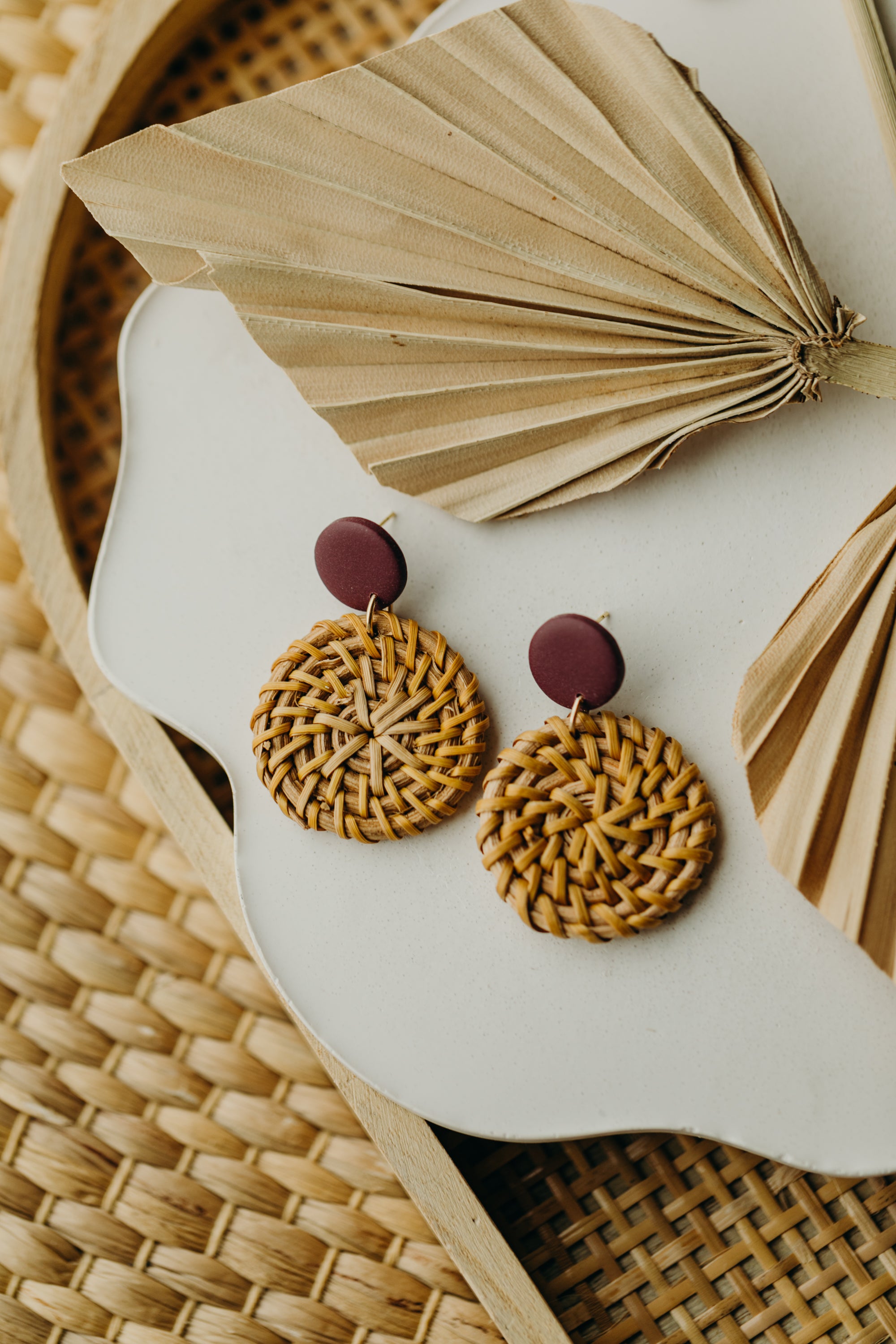 Polymer clay earrings in the color Merlot with round rattan pendant