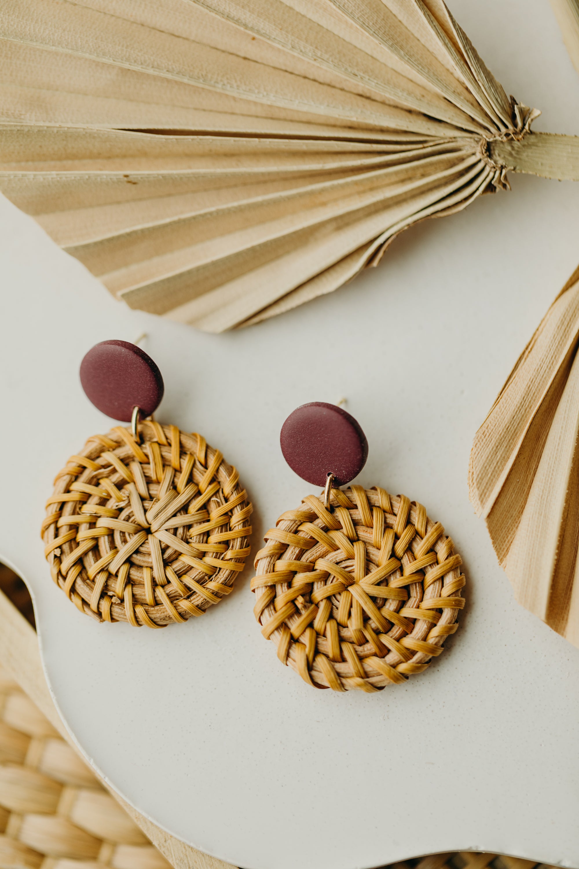 Polymer clay earrings in the color Merlot with round rattan pendant