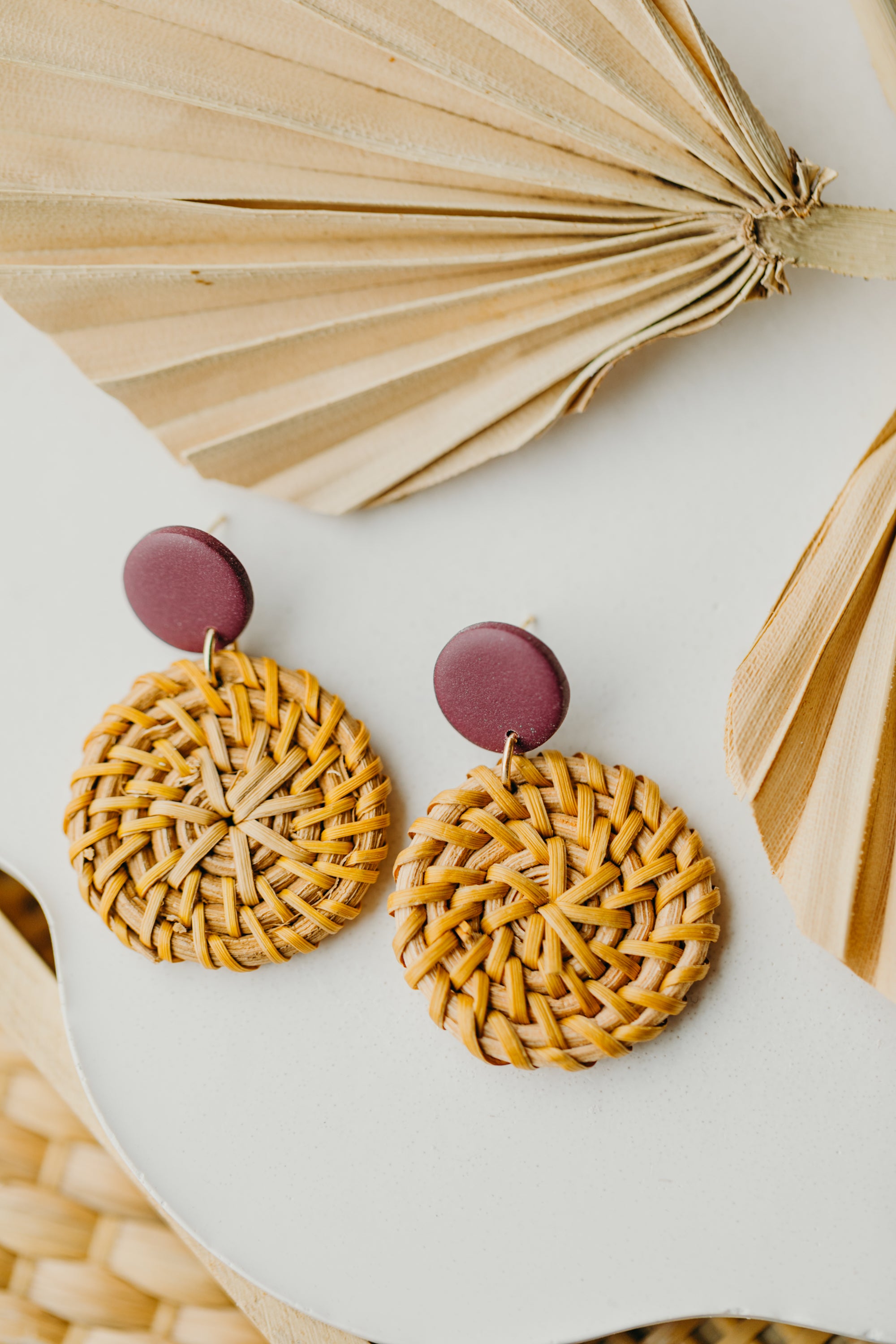 Polymer clay earrings in the color Merlot with round rattan pendant