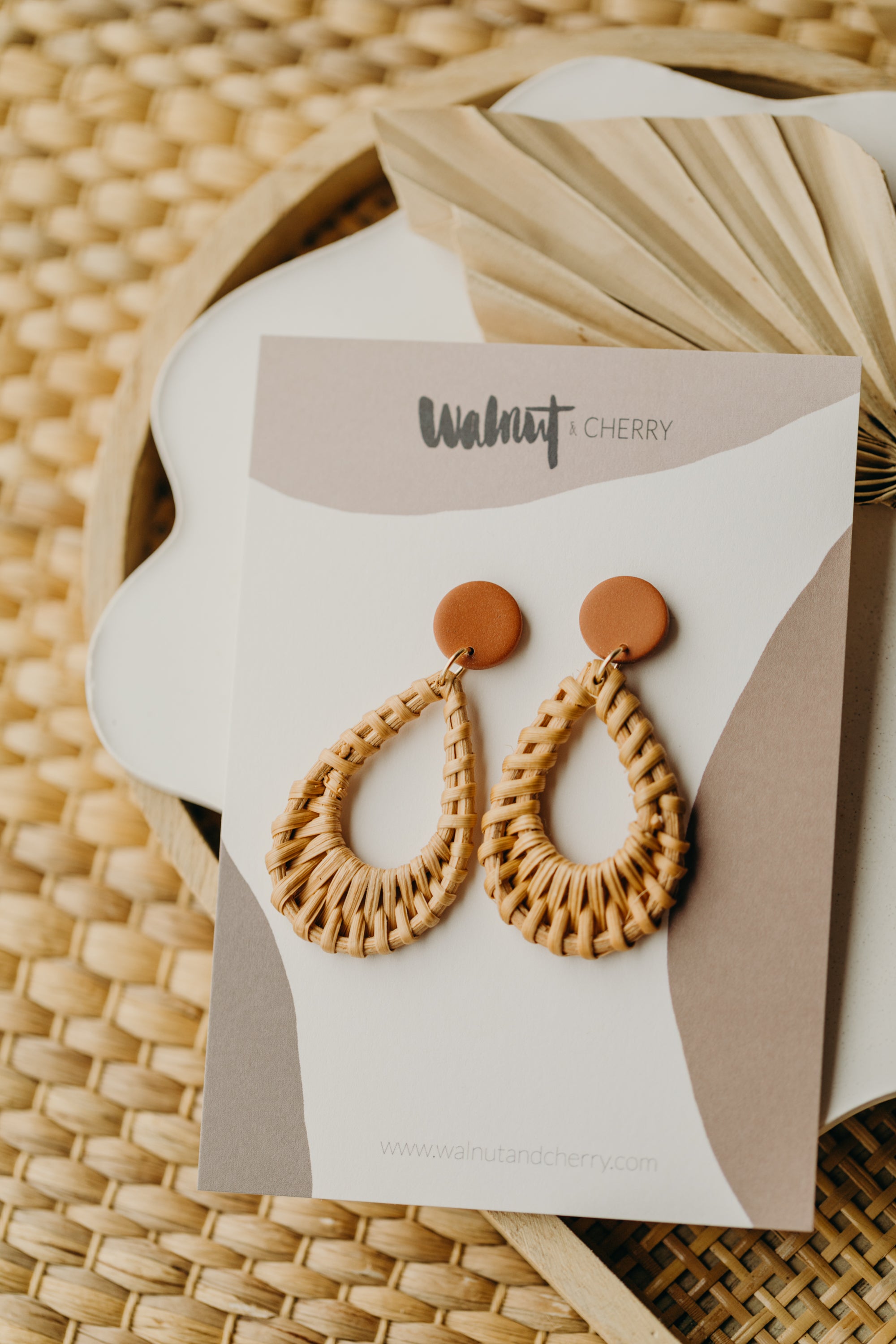 round polymer clay earrings in the color cinnamon with rattan pendant drops