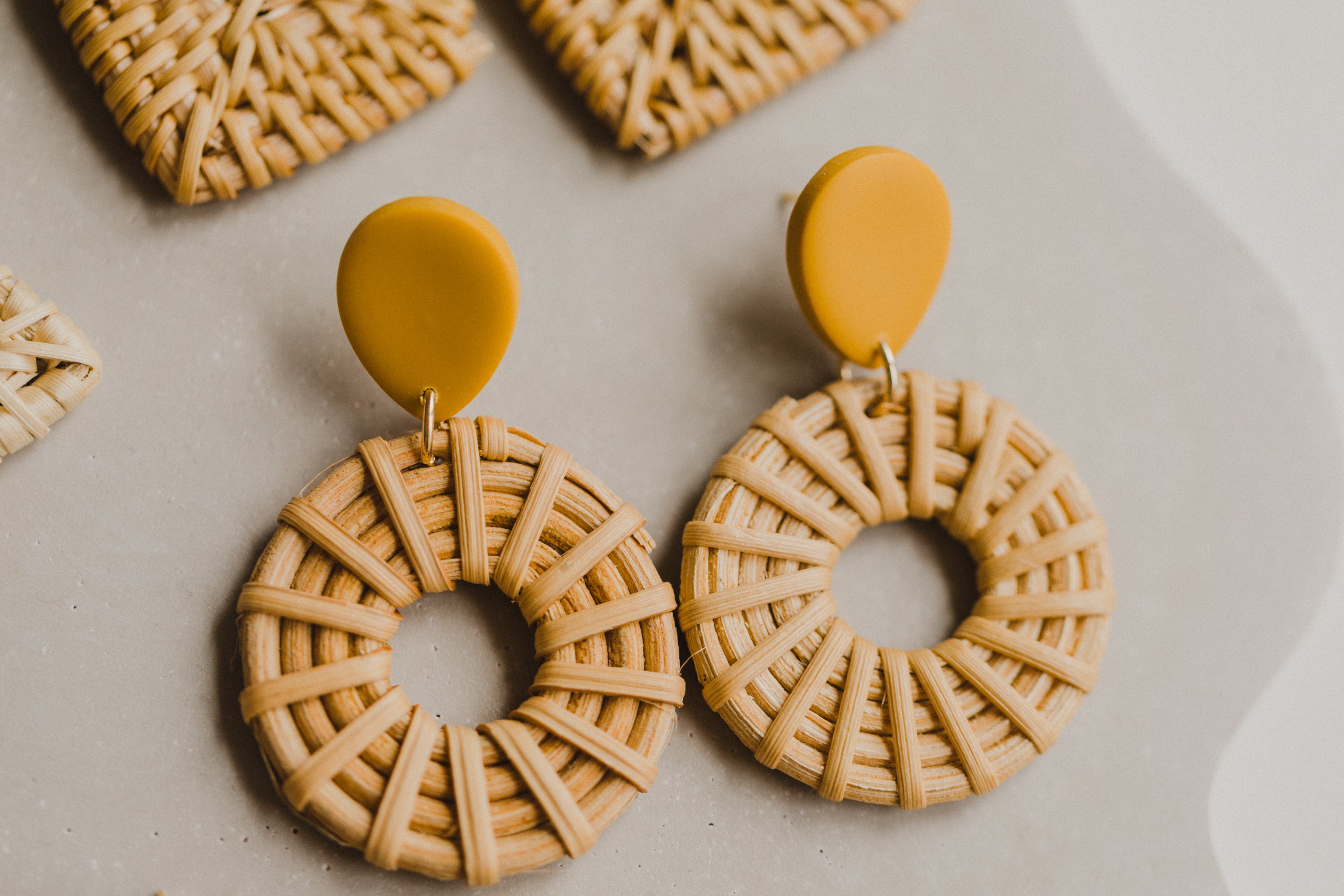 round polymer clay earrings in mustard yellow with rattan pendant circle