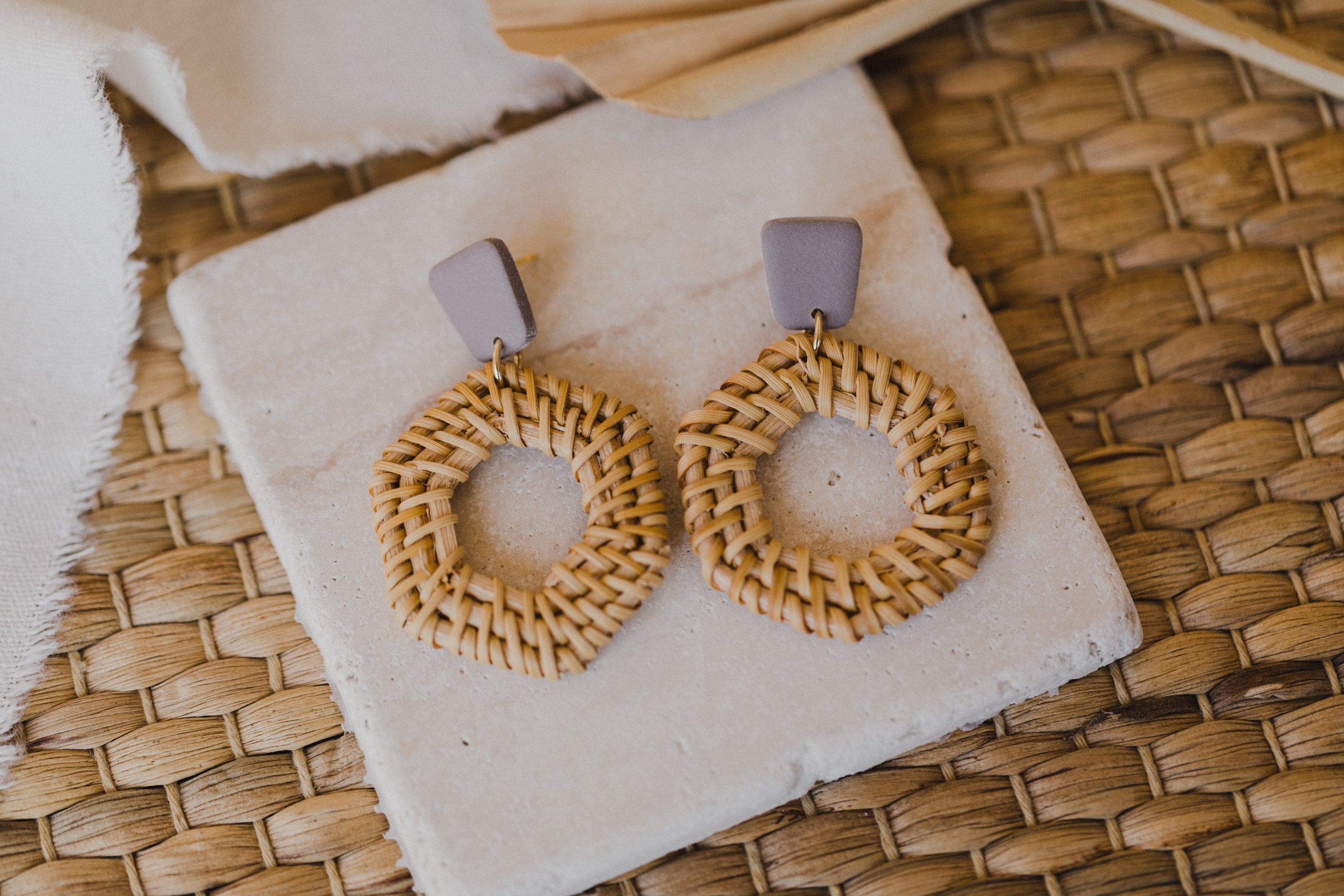 square polymer clay earrings in the color gray-purple with rattan pendant hexagon