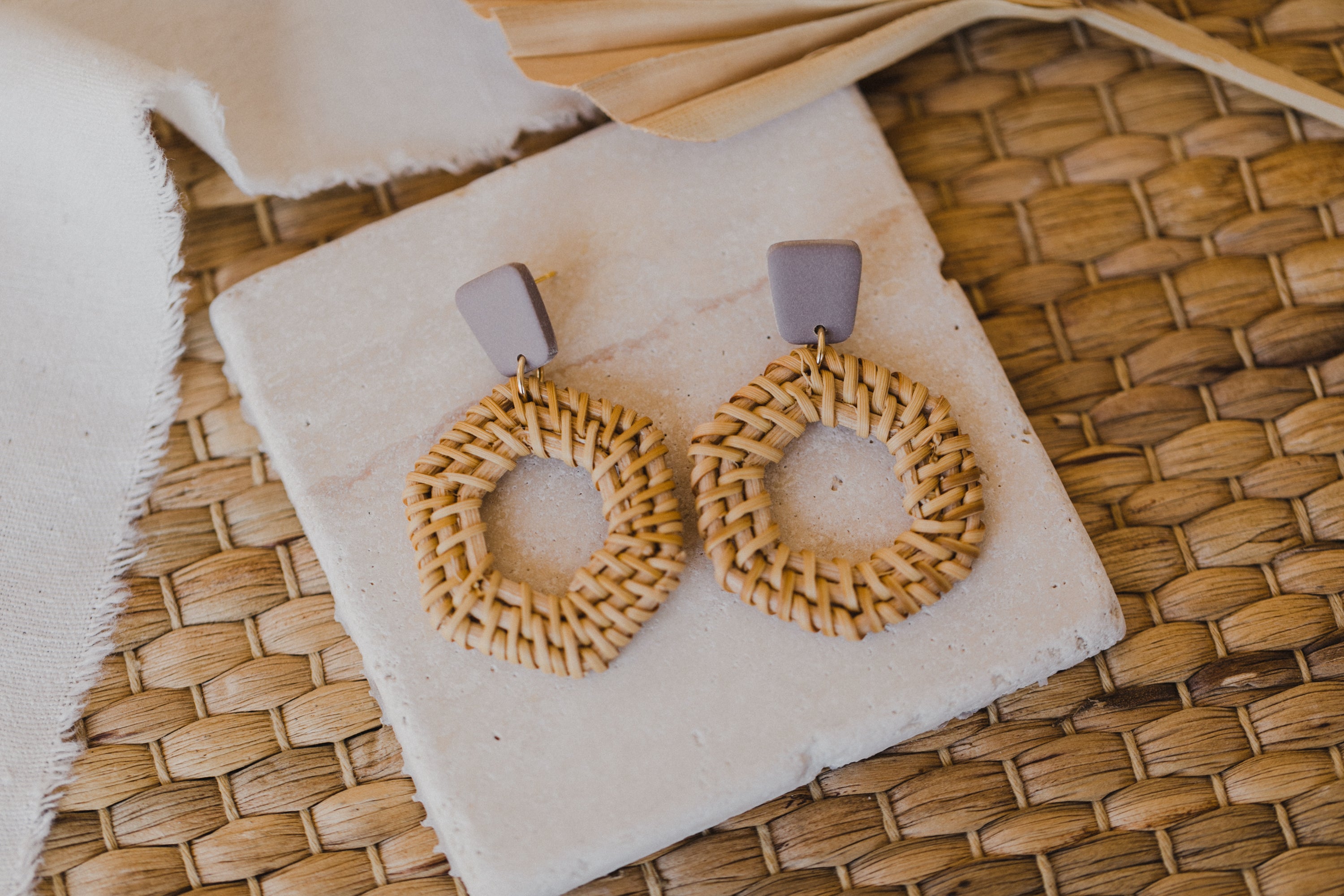 square polymer clay earrings in the color gray-purple with rattan pendant hexagon