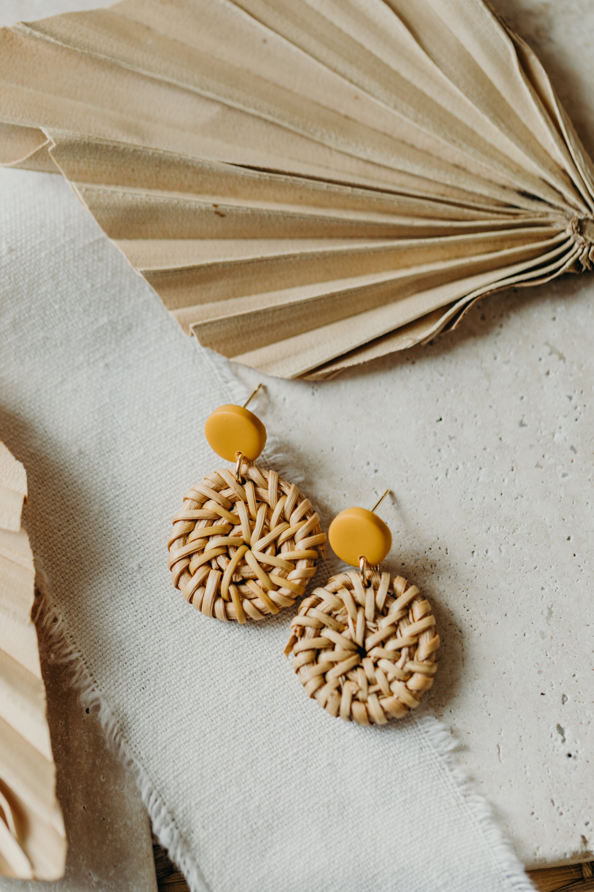 round polymer clay earrings in mustard yellow with round rattan pendant